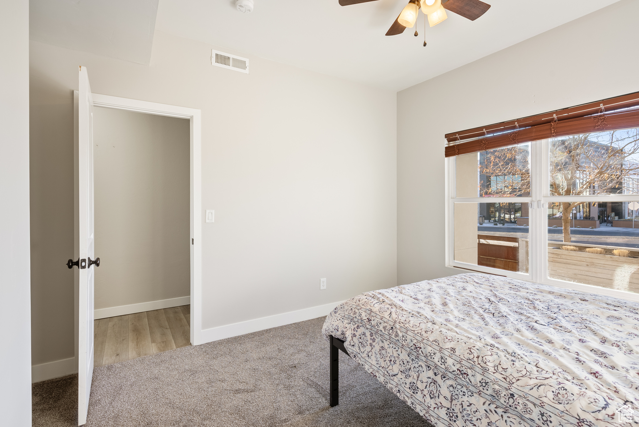 Bedroom featuring ceiling fan and carpet floors