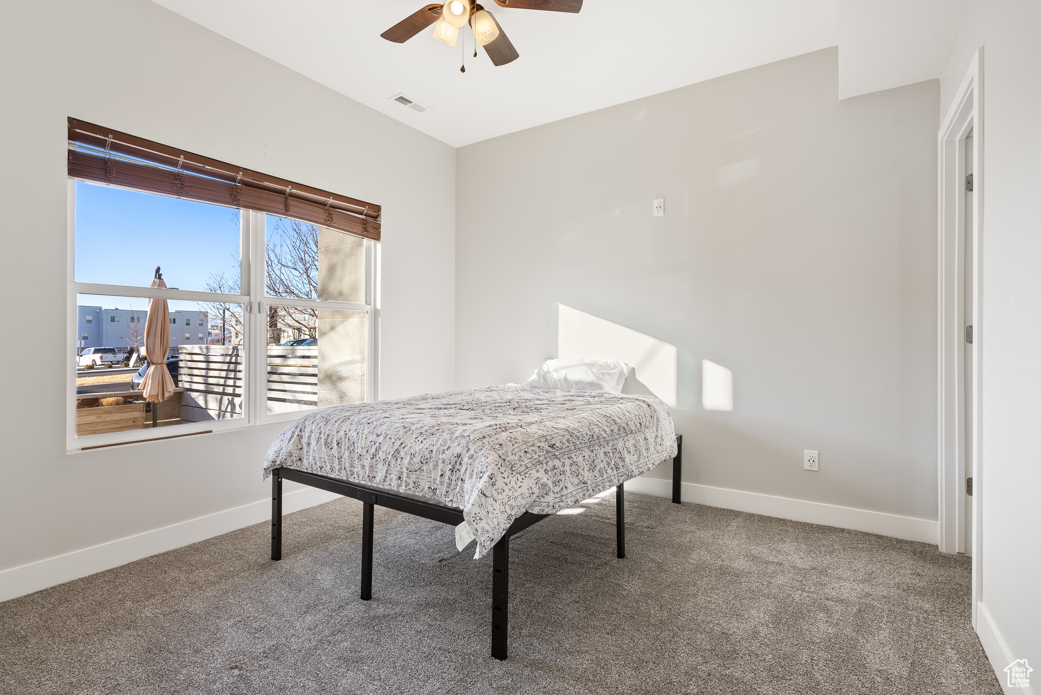 Bedroom with carpet flooring and ceiling fan