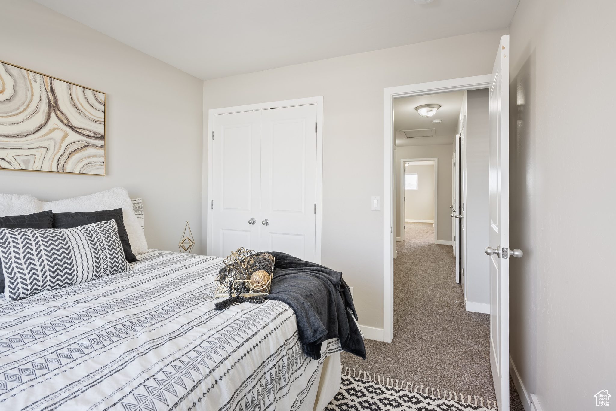 Carpeted bedroom with a closet