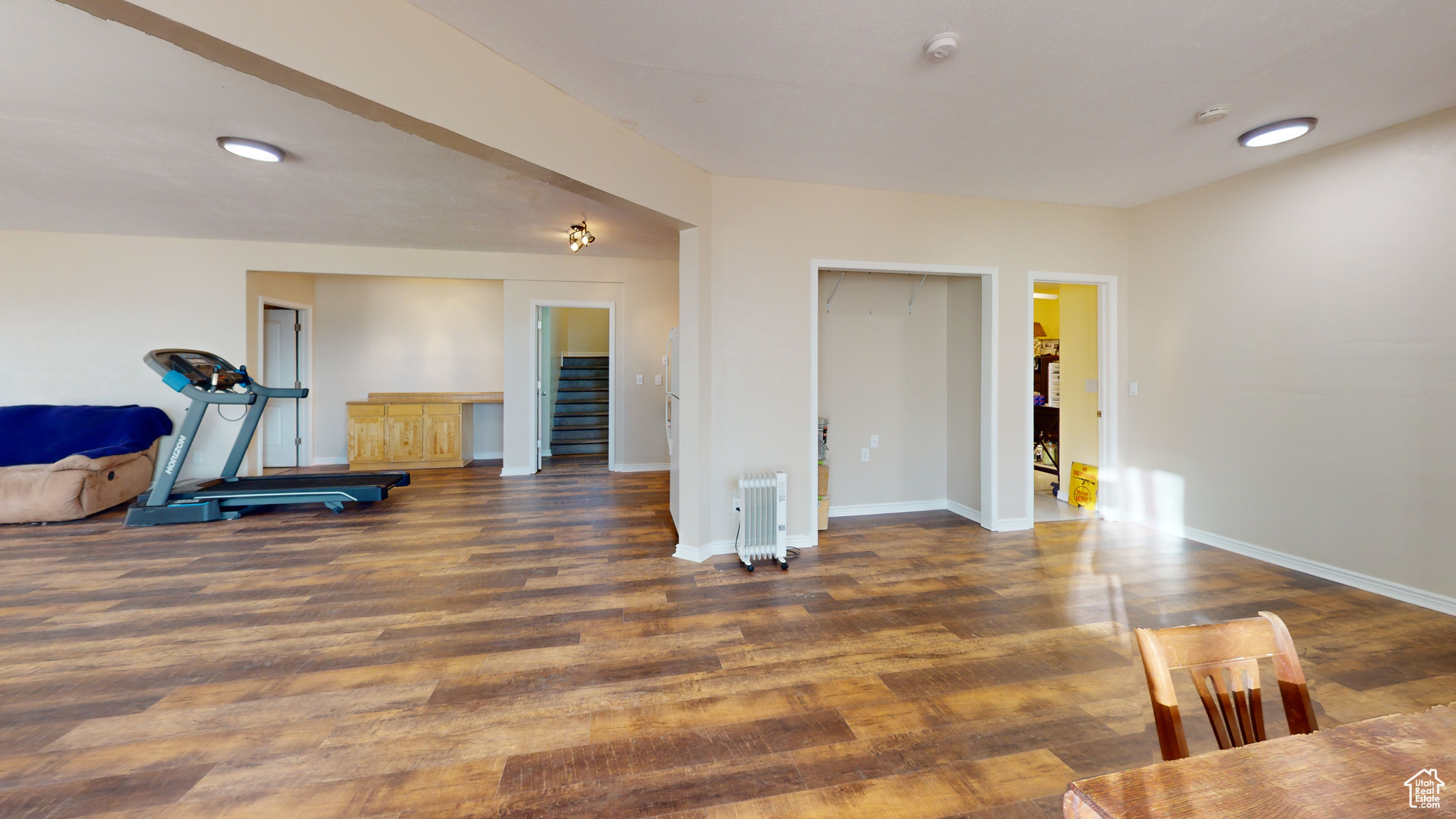 Workout room featuring dark hardwood / wood-style floors and radiator