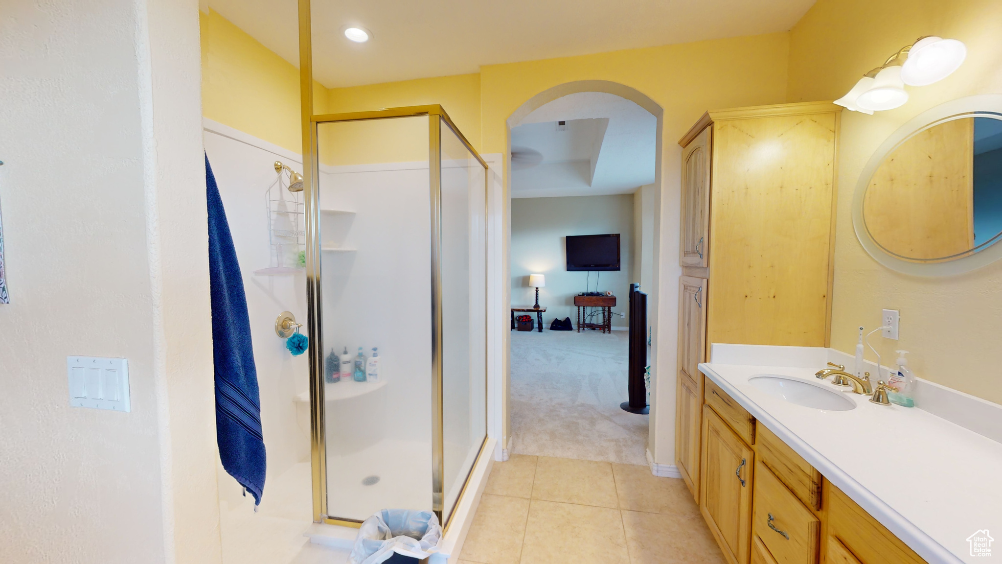 Bathroom with tile patterned floors, vanity, and walk in shower