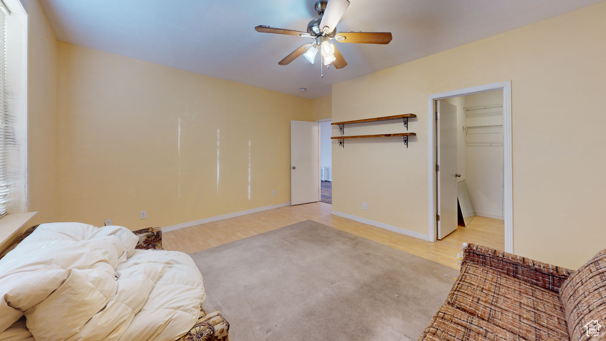 Living area featuring ceiling fan and light hardwood / wood-style flooring