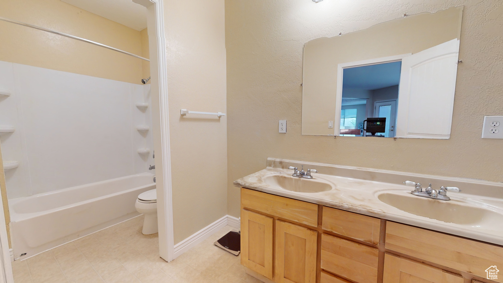 Full bathroom featuring shower / bathing tub combination, tile patterned flooring, vanity, and toilet