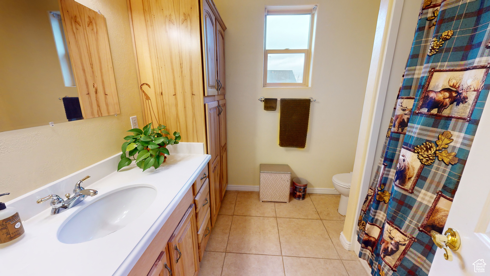 Bathroom featuring tile patterned flooring, vanity, and toilet