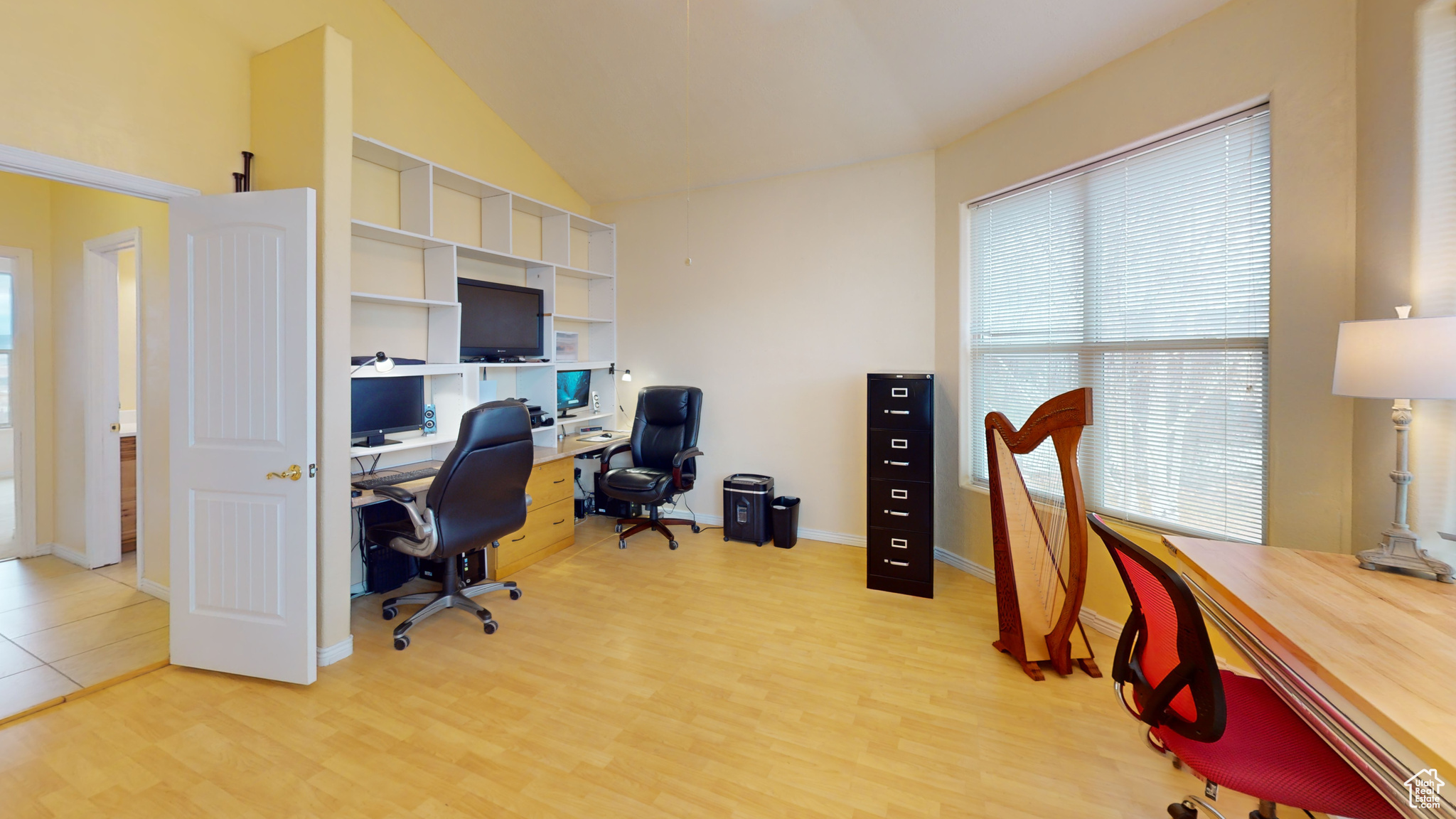 Office area featuring light hardwood / wood-style floors and lofted ceiling