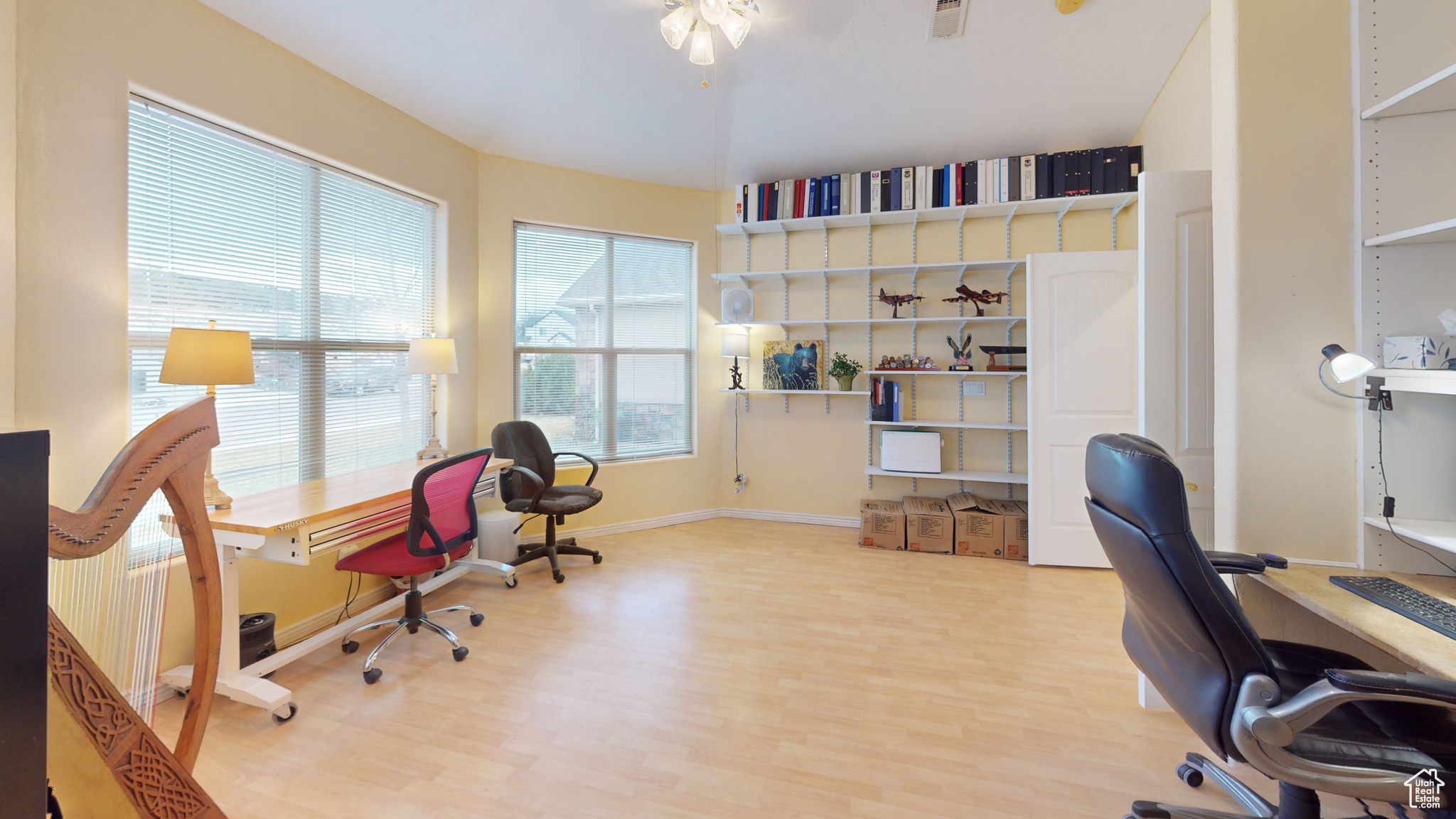 Office area with light hardwood / wood-style floors