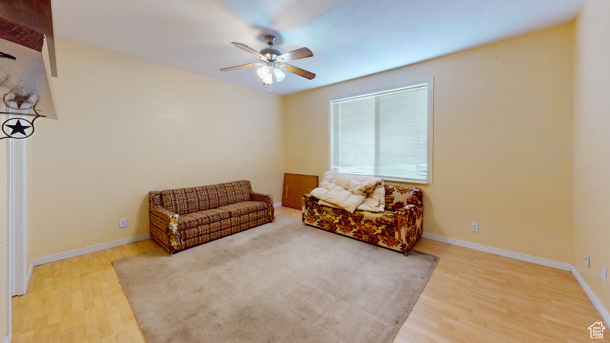 Living area featuring ceiling fan and hardwood / wood-style flooring