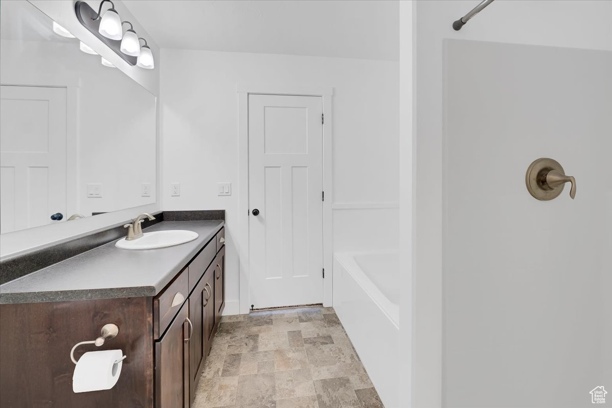 Bathroom featuring bathtub / shower combination and vanity