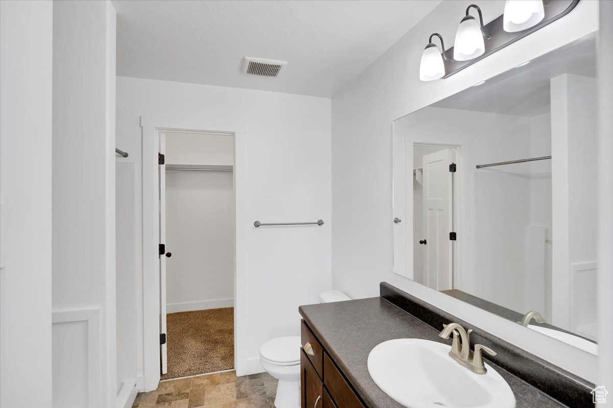 Bathroom featuring vanity and toilet