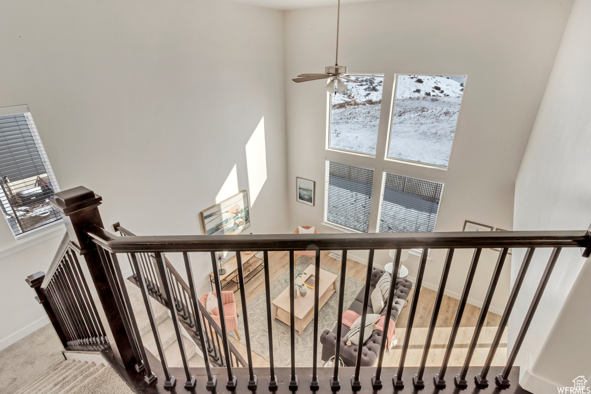 Stairs featuring carpet, a towering ceiling, and ceiling fan