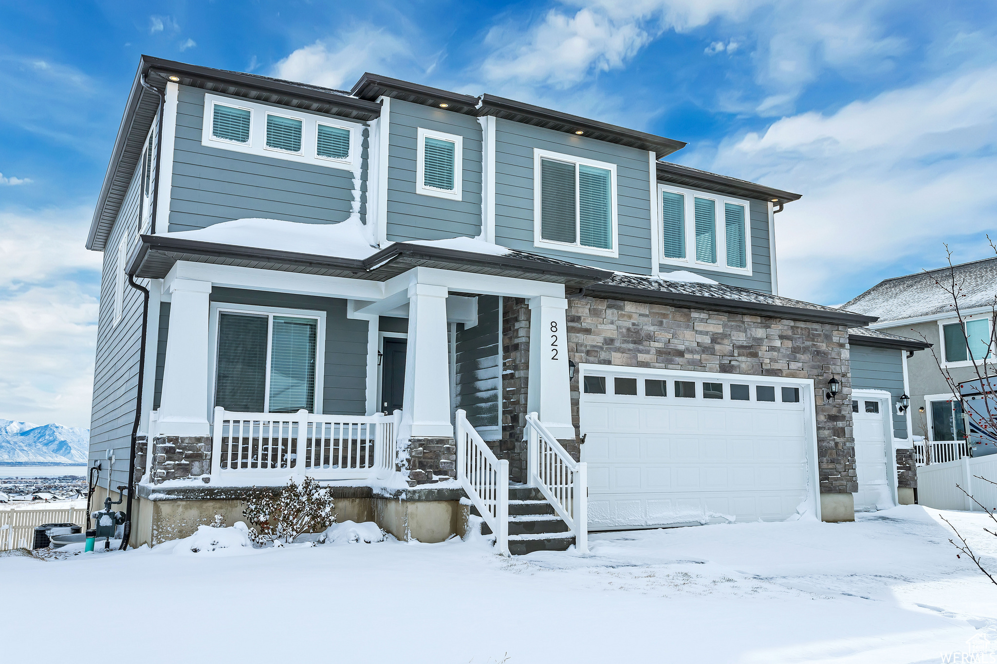 View of front facade with a porch and a garage