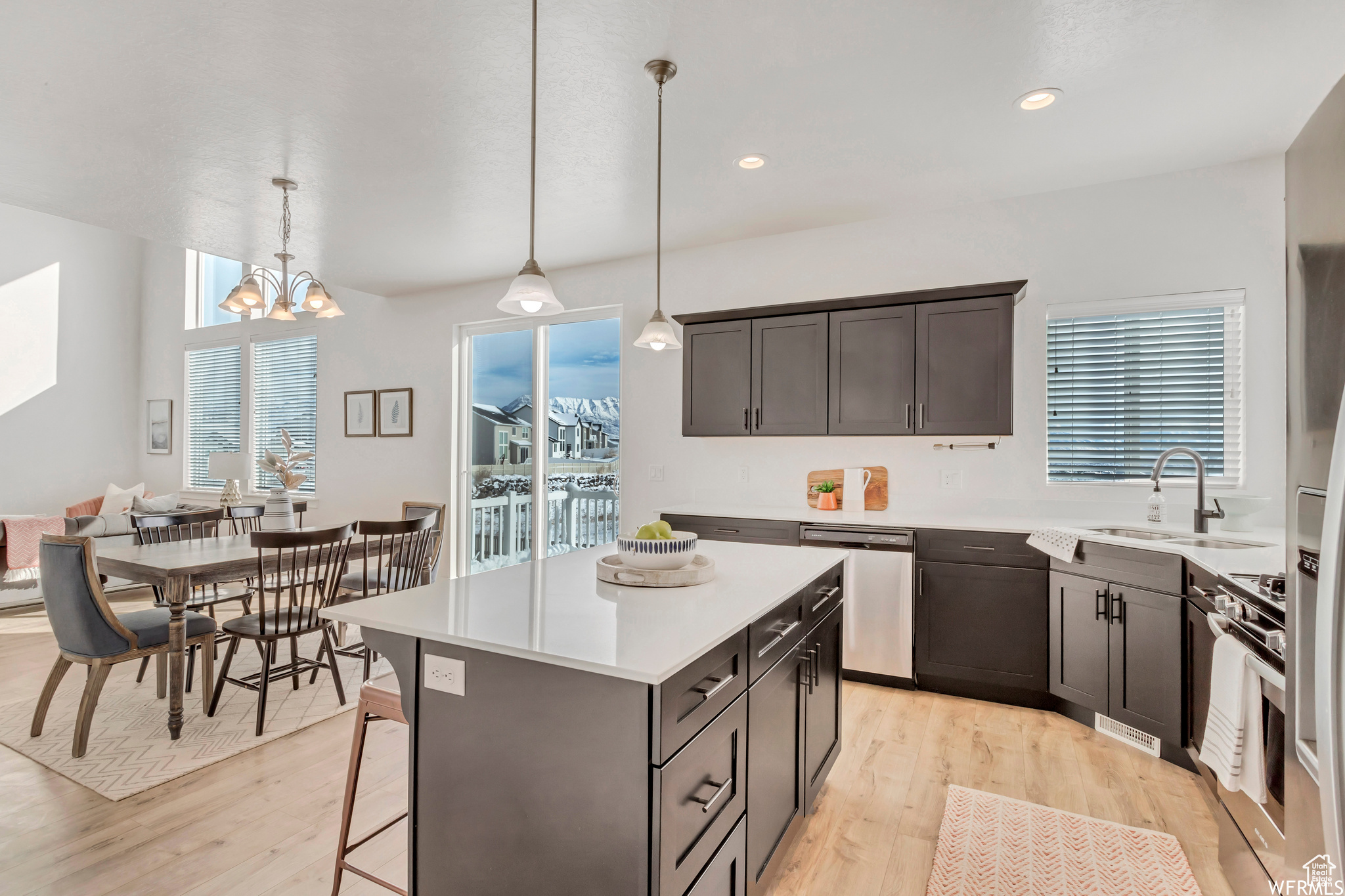 Kitchen featuring appliances with stainless steel finishes, plenty of natural light, pendant lighting, and sink