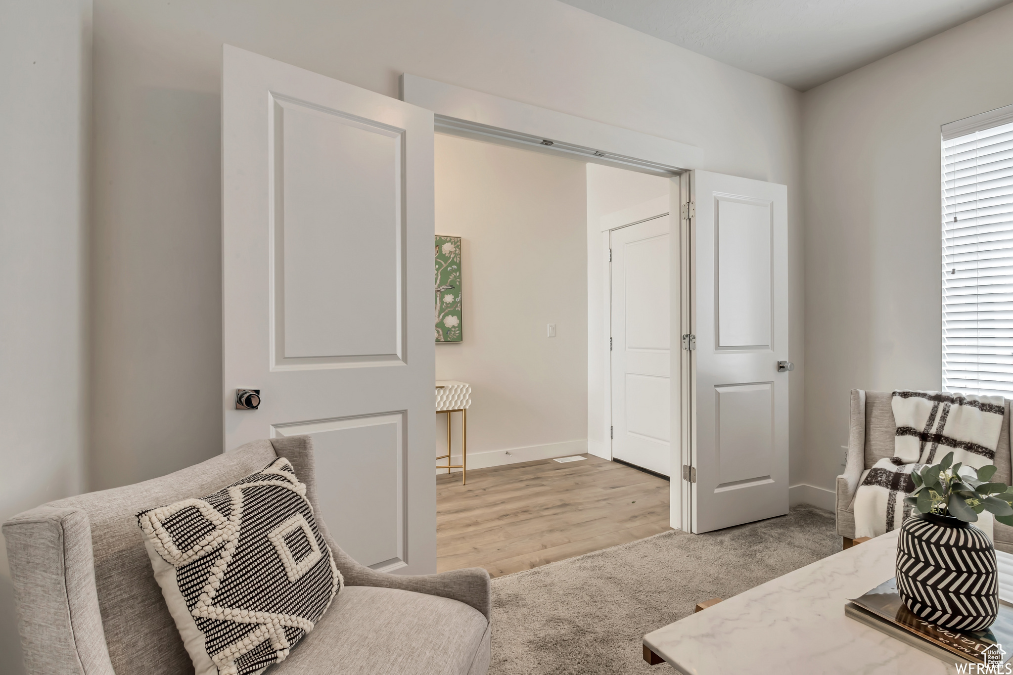 Sitting room with light hardwood / wood-style floors and plenty of natural light