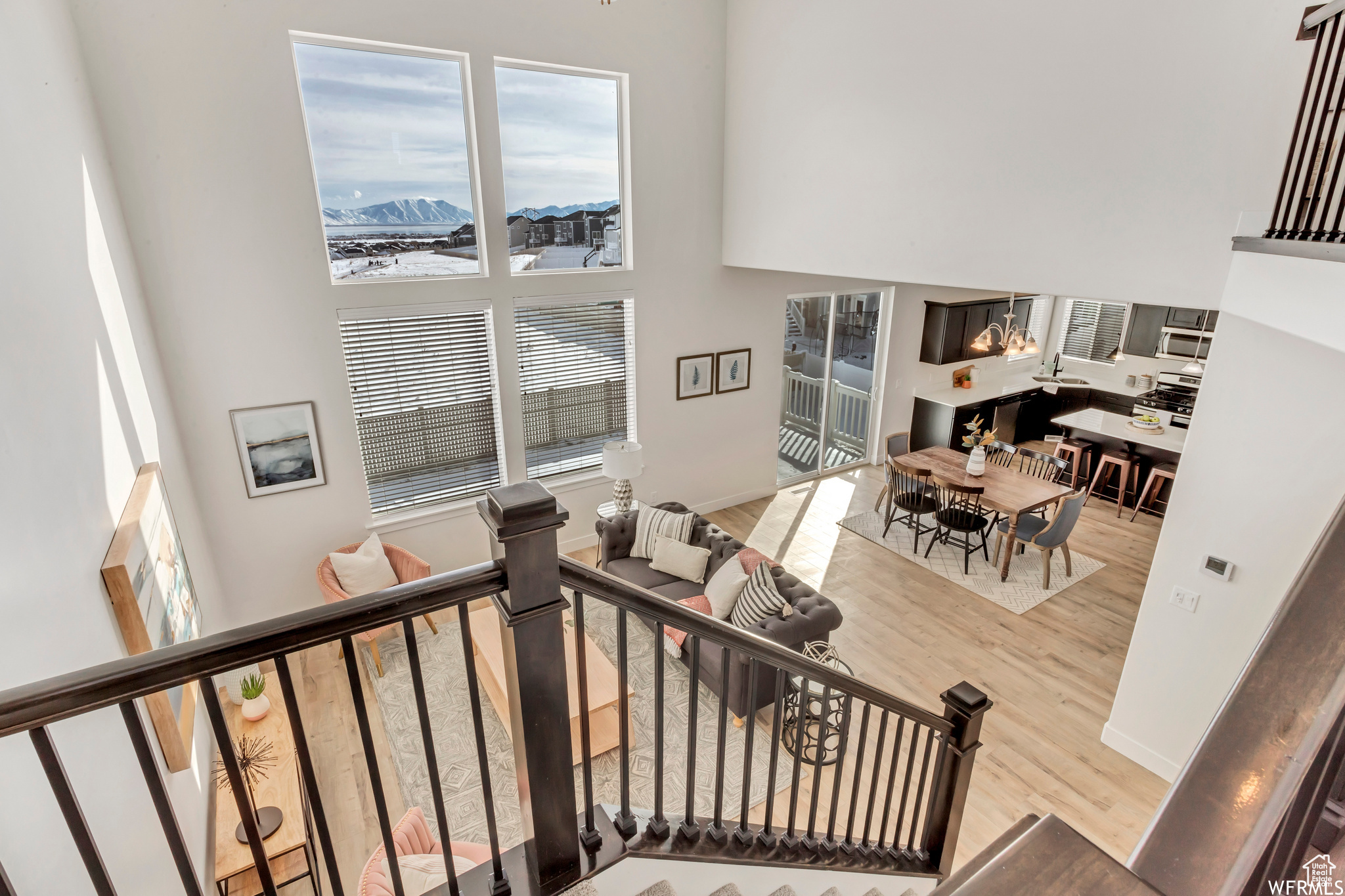 Stairs featuring a mountain view, a towering ceiling, and hardwood / wood-style flooring