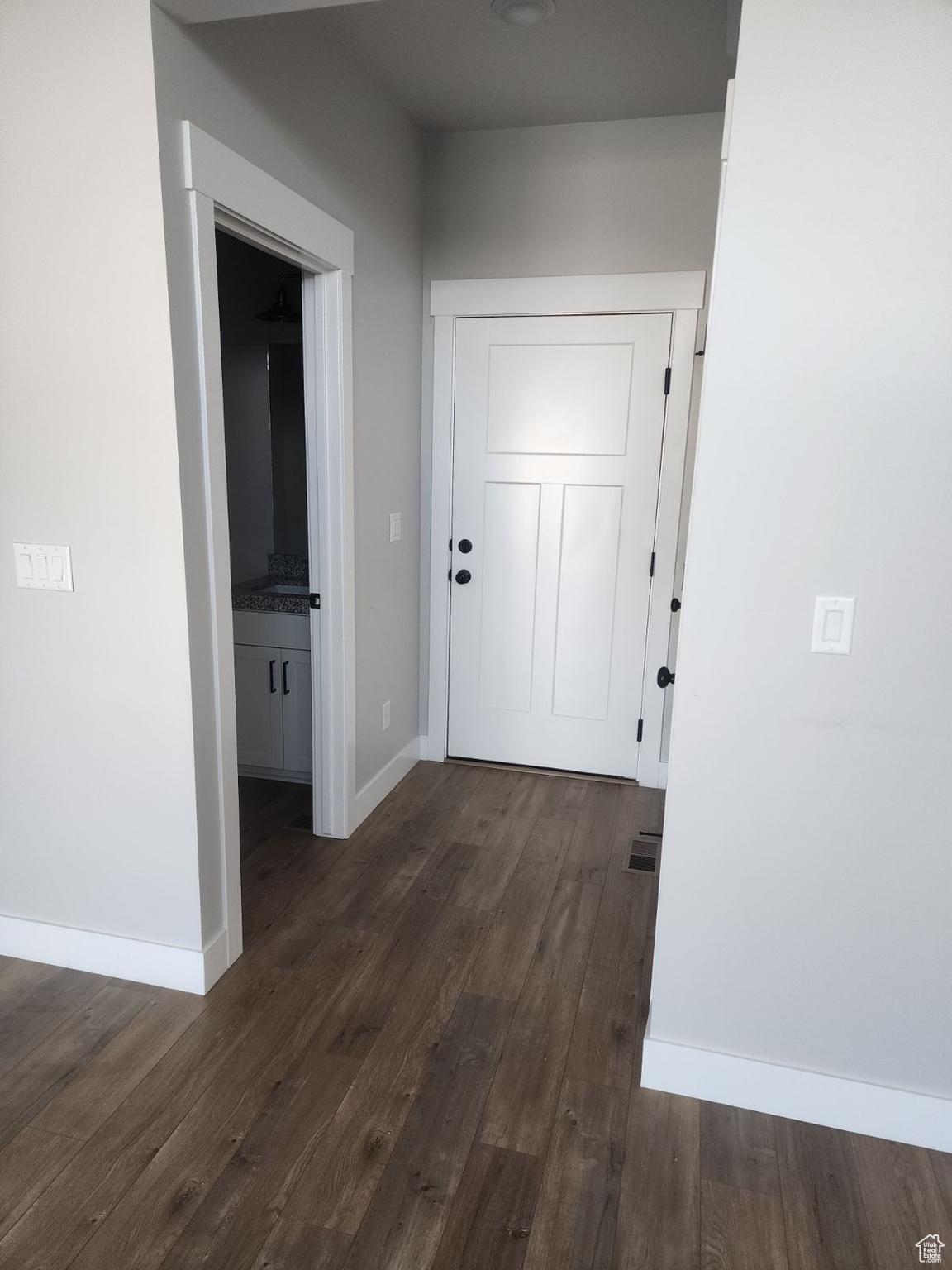 Hallway featuring dark wood-type flooring