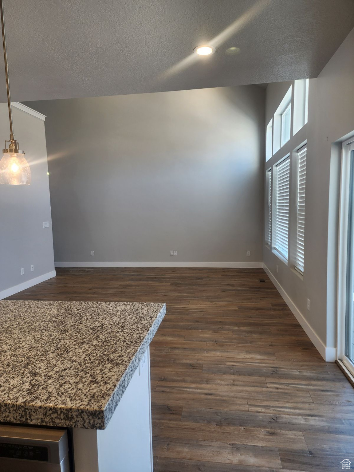 Interior space featuring a textured ceiling and dark hardwood / wood-style floors