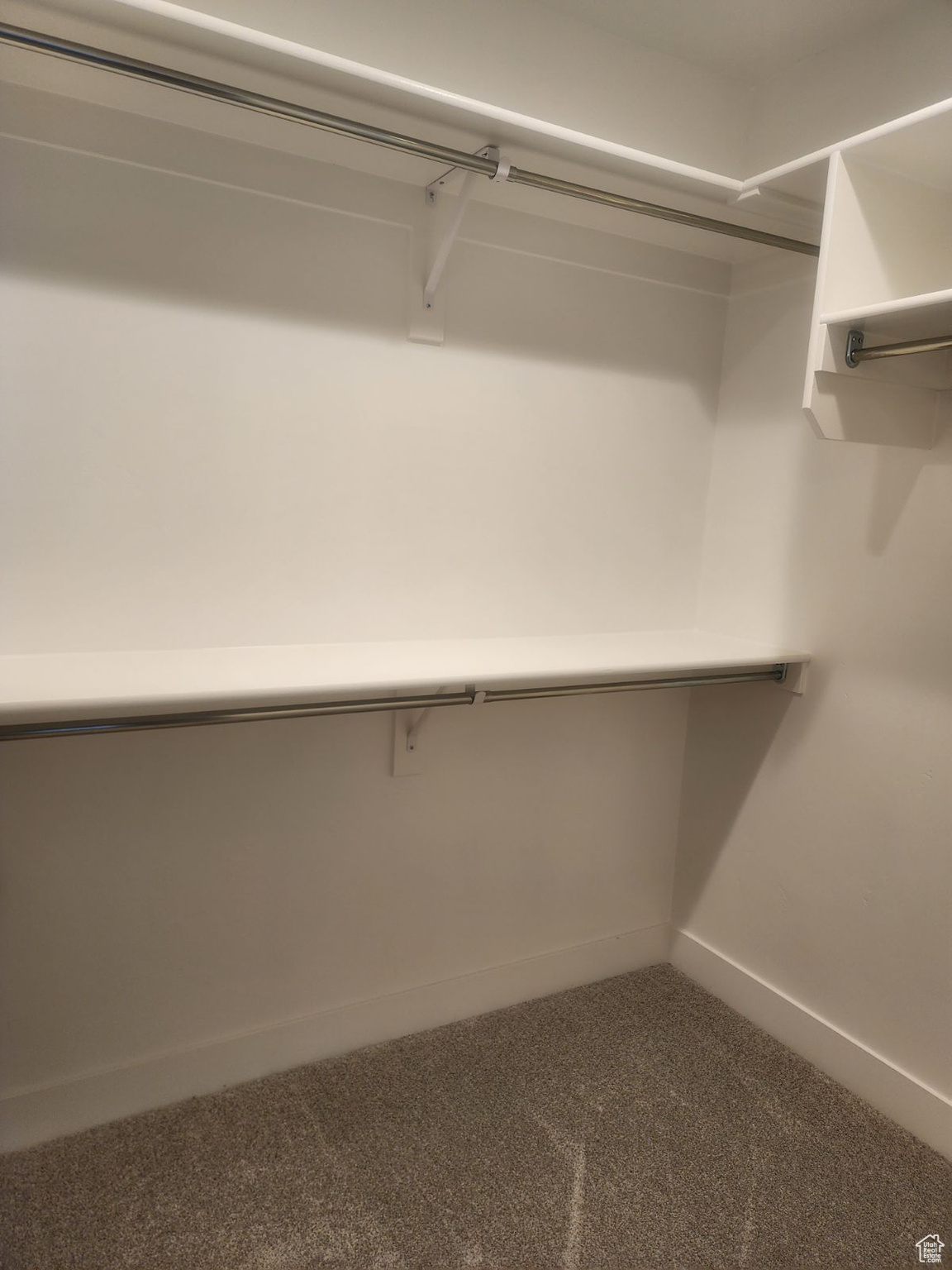 Spacious closet with carpet floors