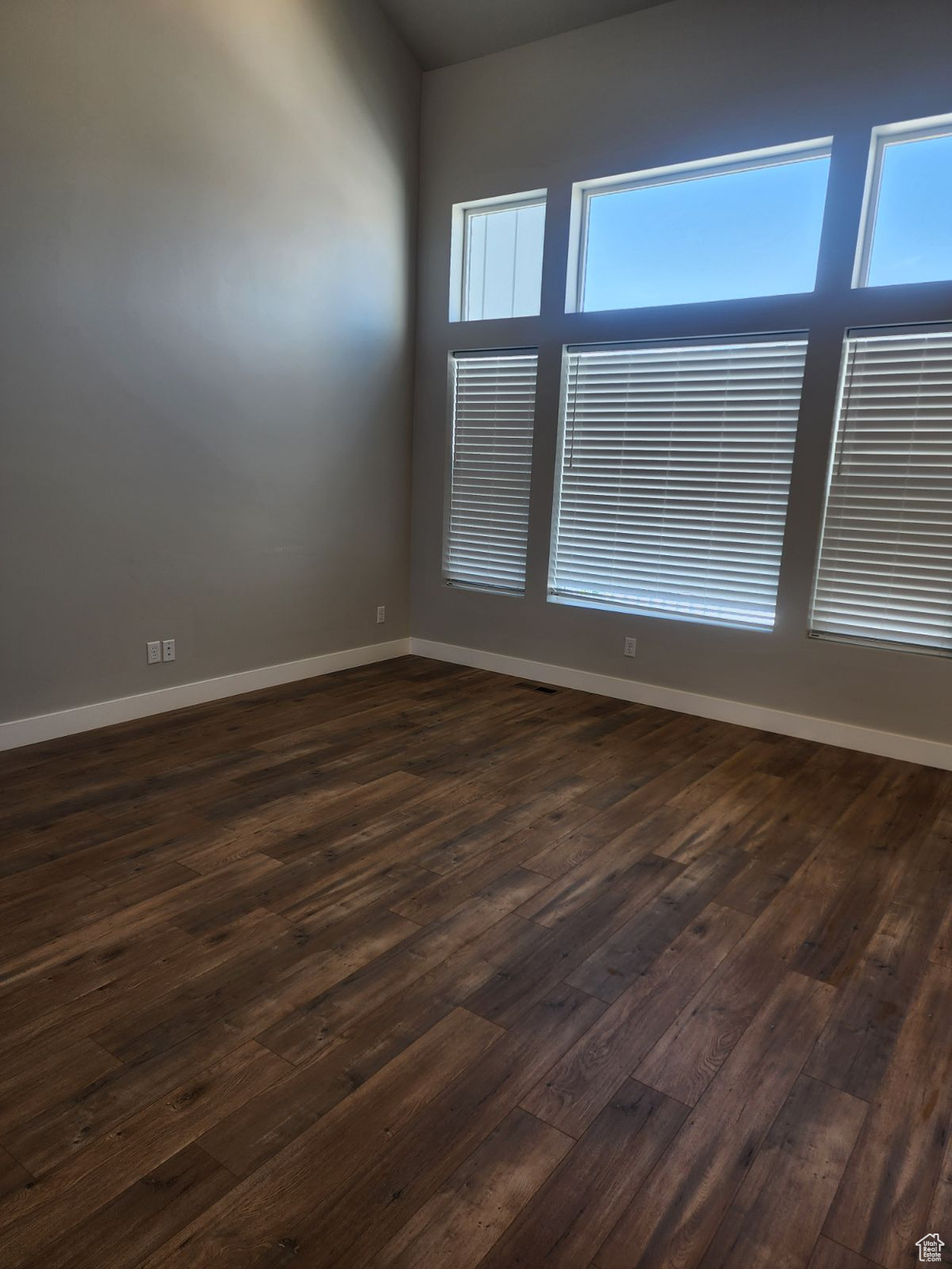 Unfurnished room featuring dark wood-type flooring