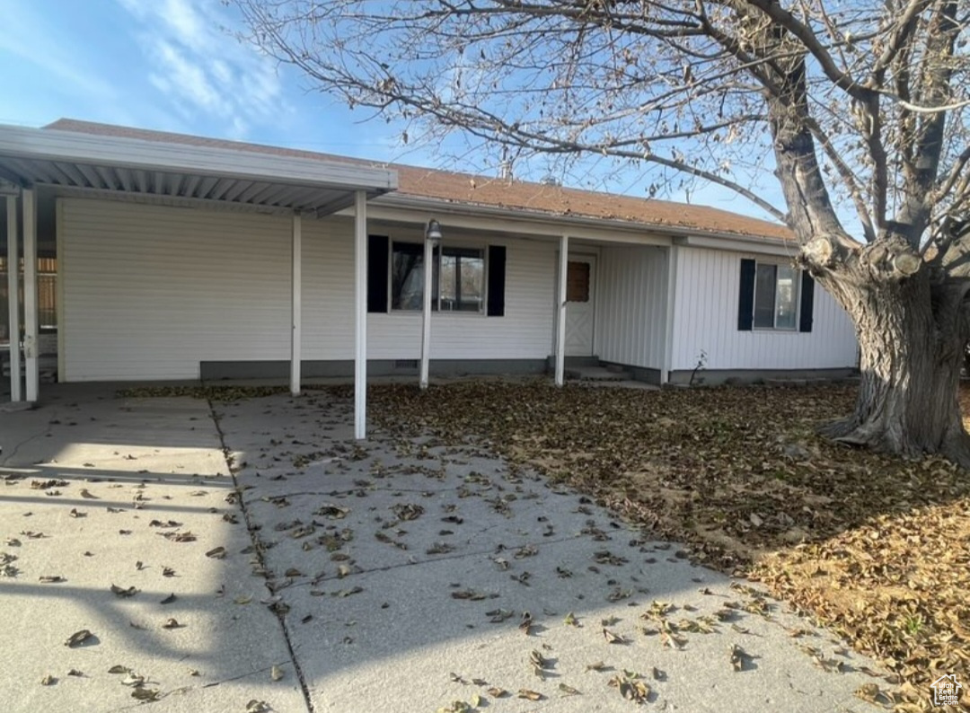 Back of house with a carport