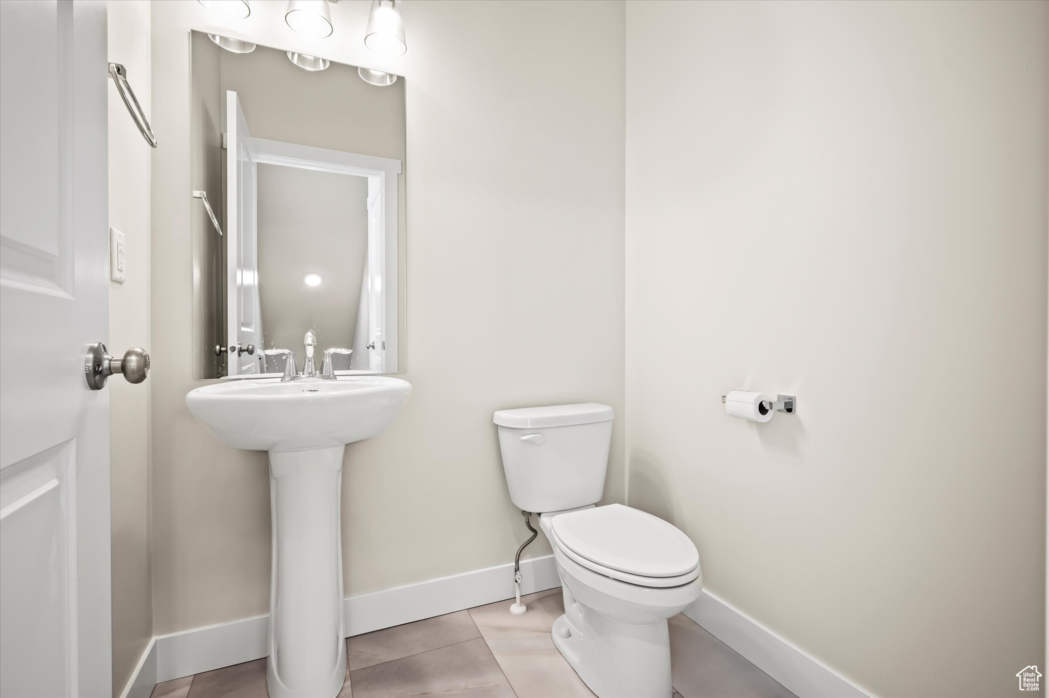 Bathroom featuring tile patterned flooring and toilet