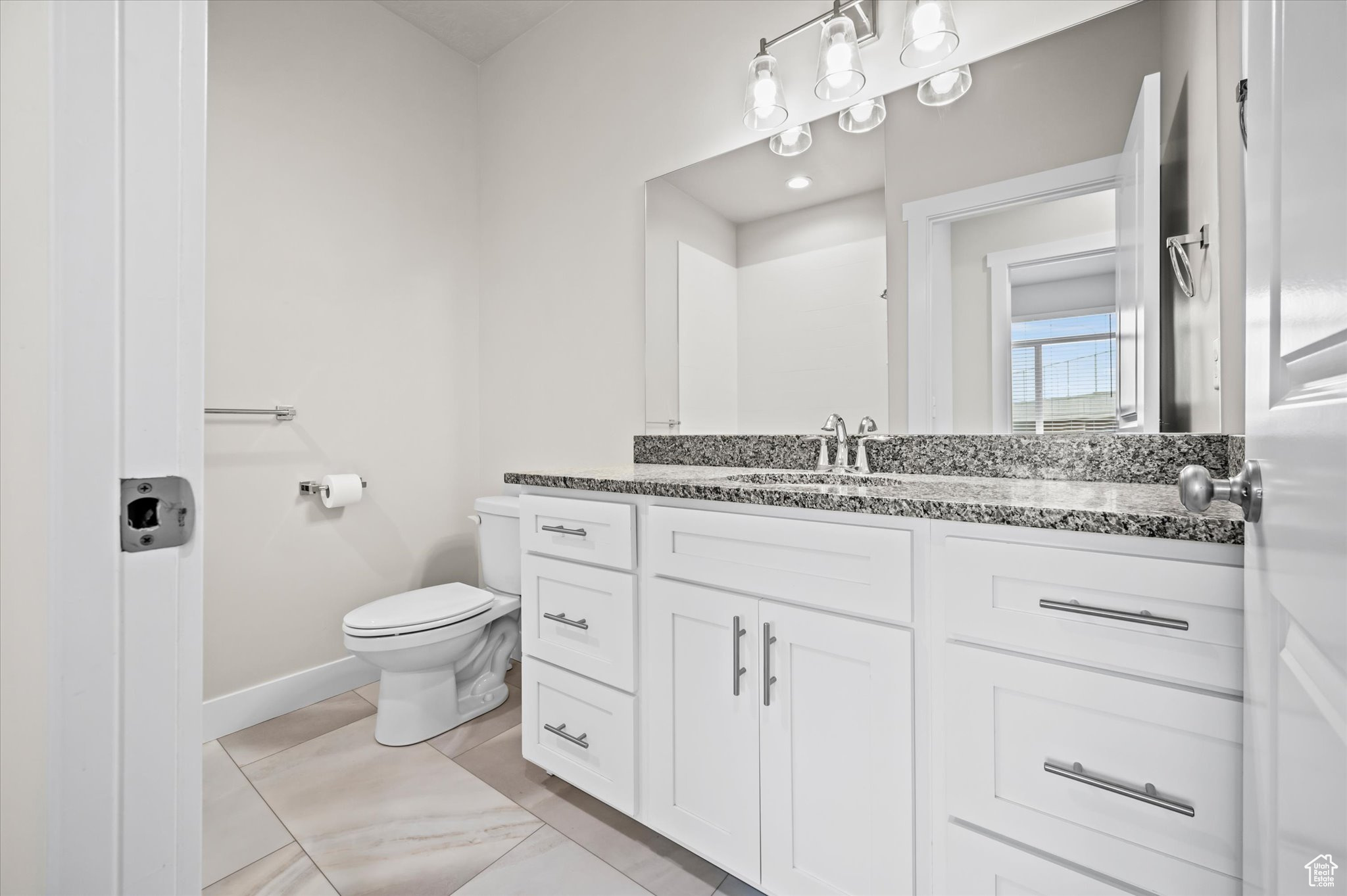 Bathroom with tile patterned flooring, vanity, and toilet