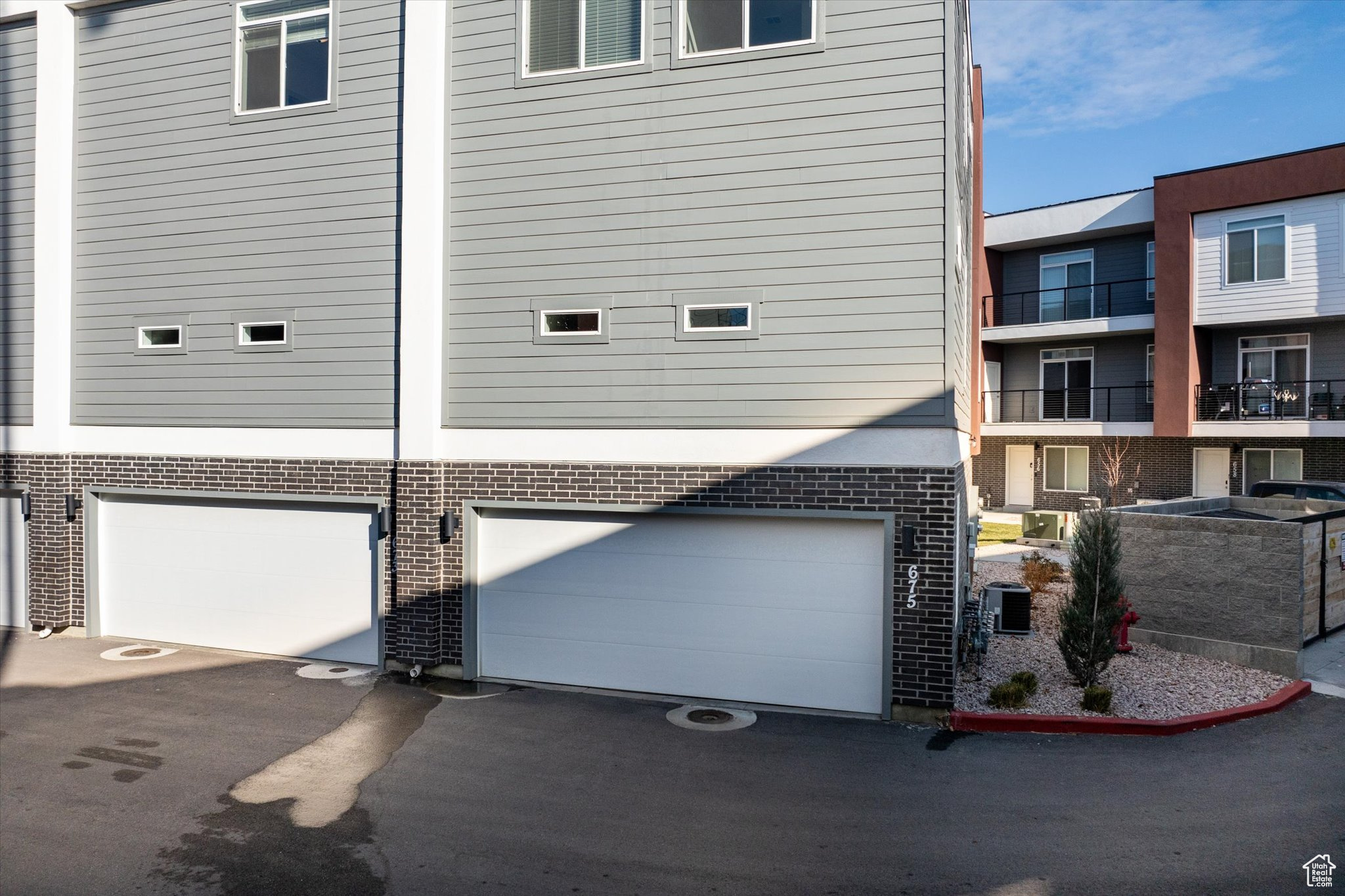 View of home's exterior featuring central AC and a garage