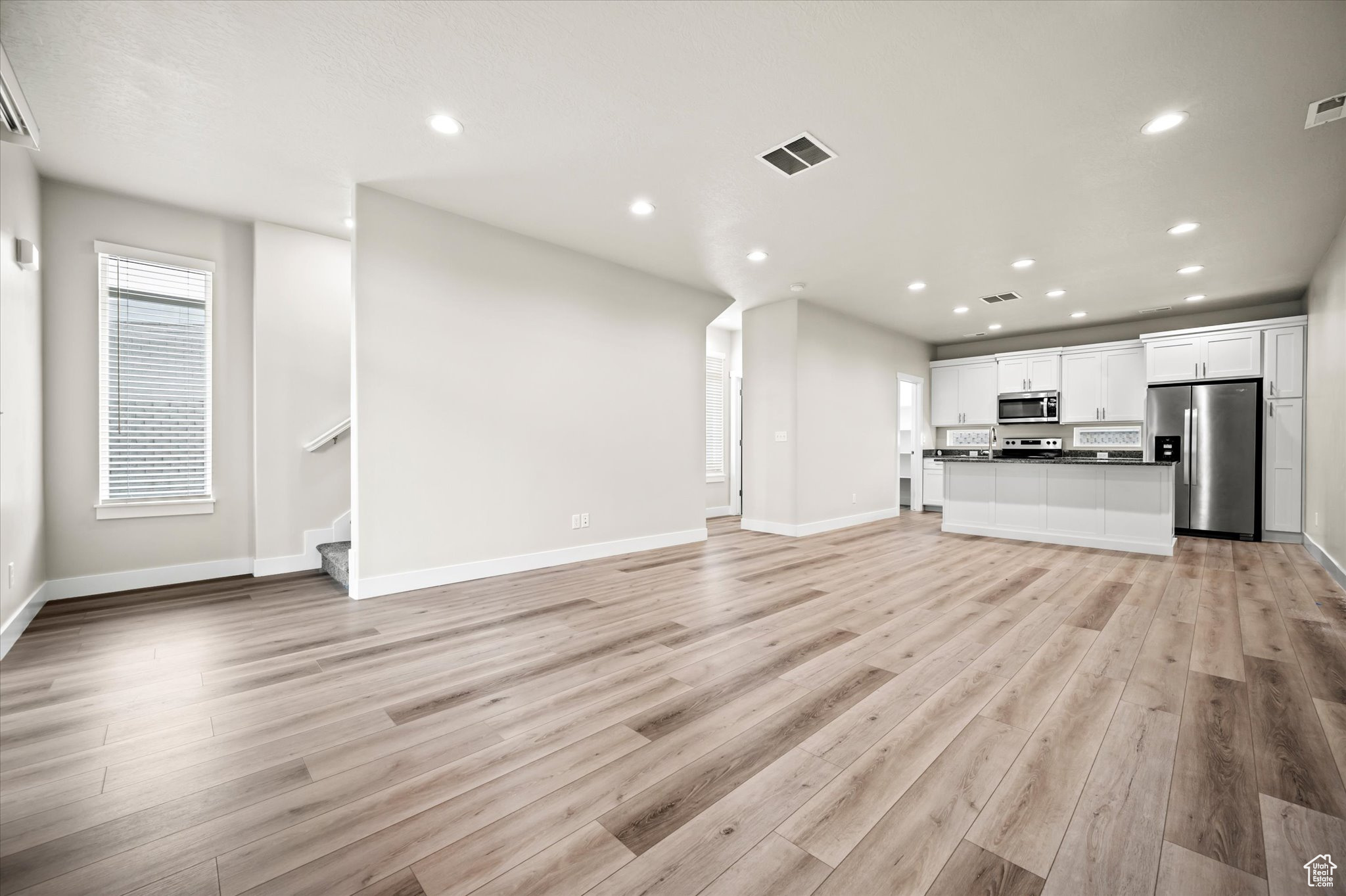 Unfurnished living room with light wood-type flooring