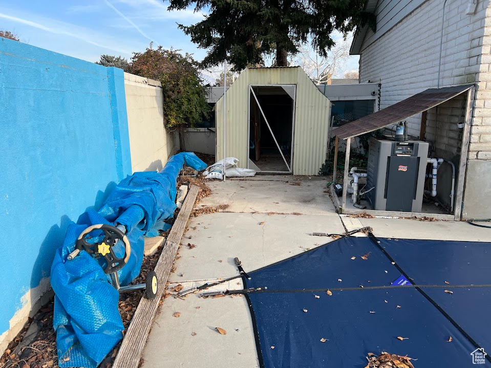 View of patio / terrace featuring a storage unit