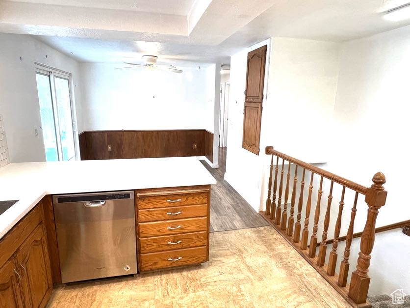 Kitchen with stainless steel dishwasher, ceiling fan, a textured ceiling, and light hardwood / wood-style flooring