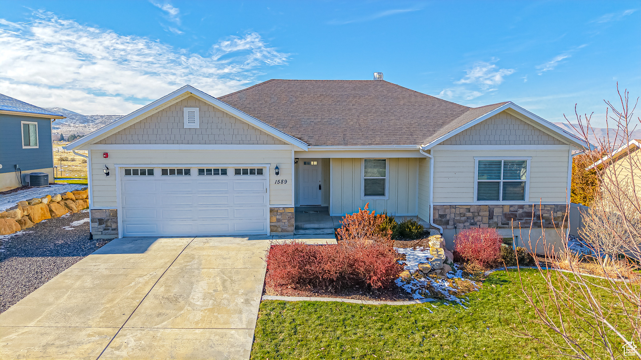 Craftsman house with central air condition unit and a garage