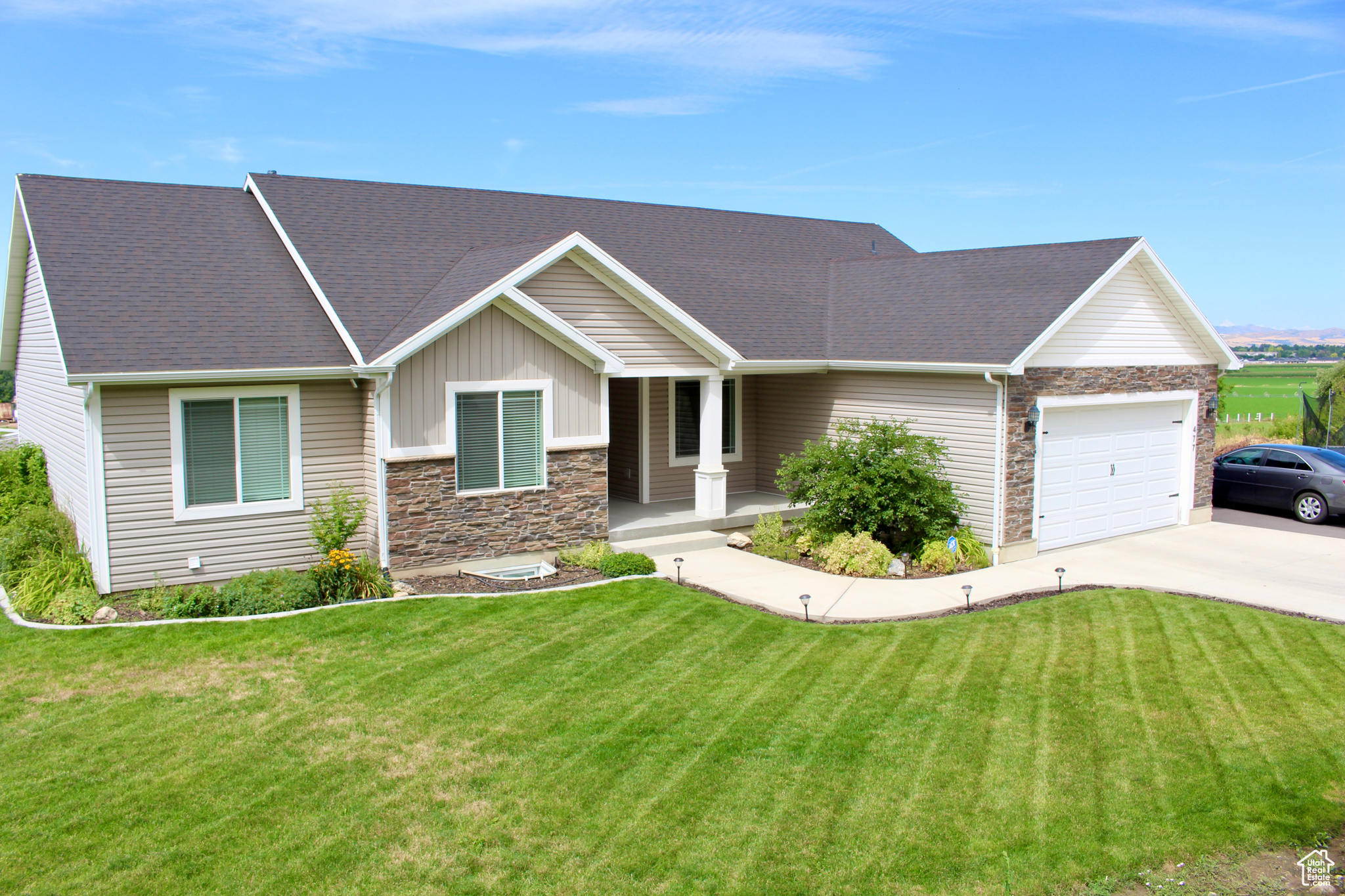 View of front facade featuring a garage and a front yard