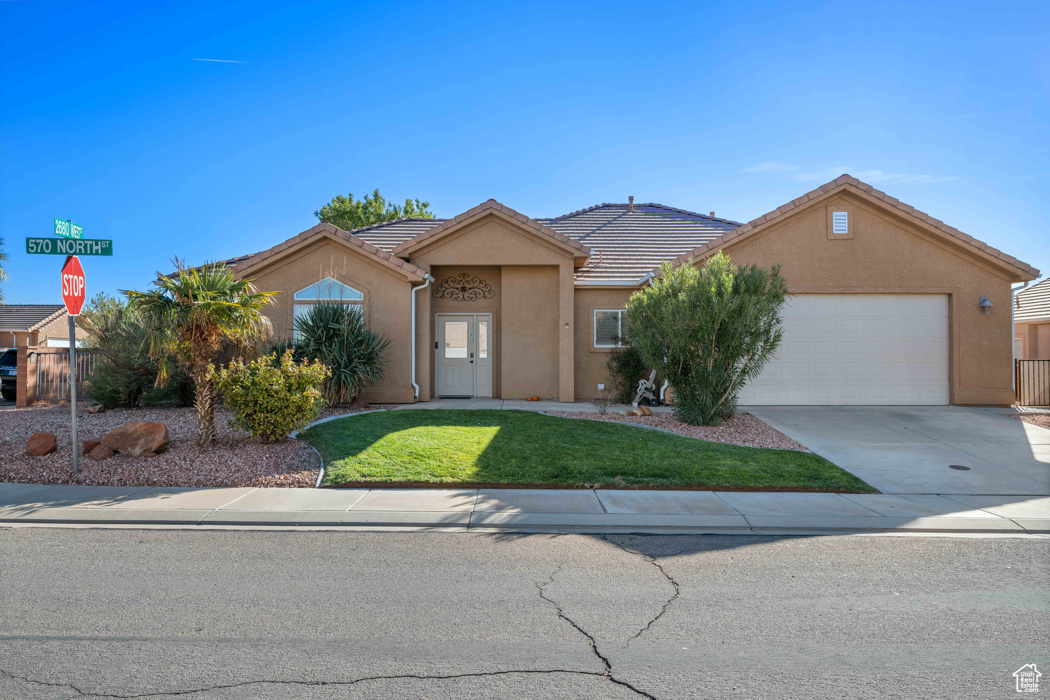 Ranch-style house with a front yard and a garage