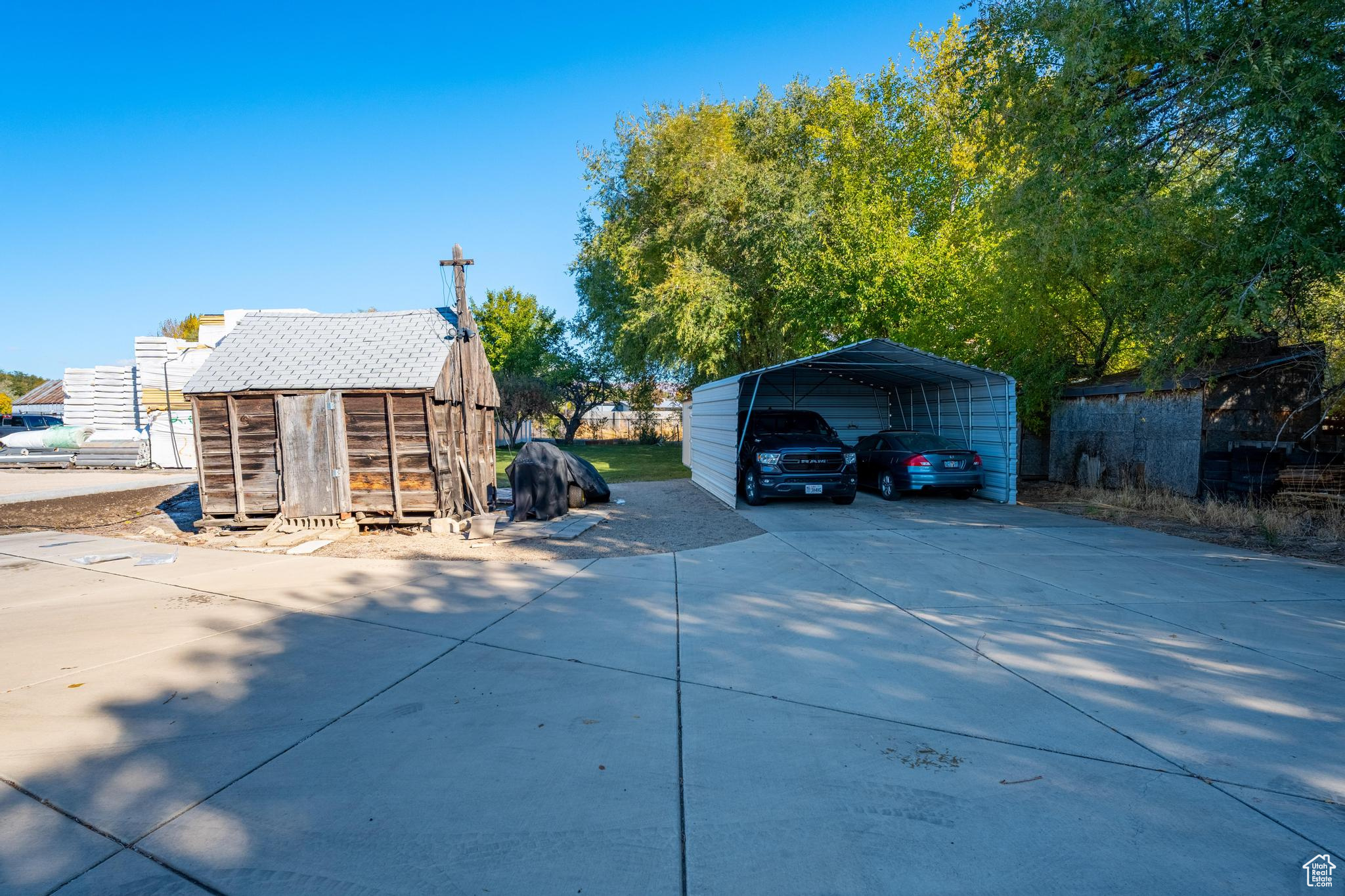 Exterior space with a carport and a storage unit