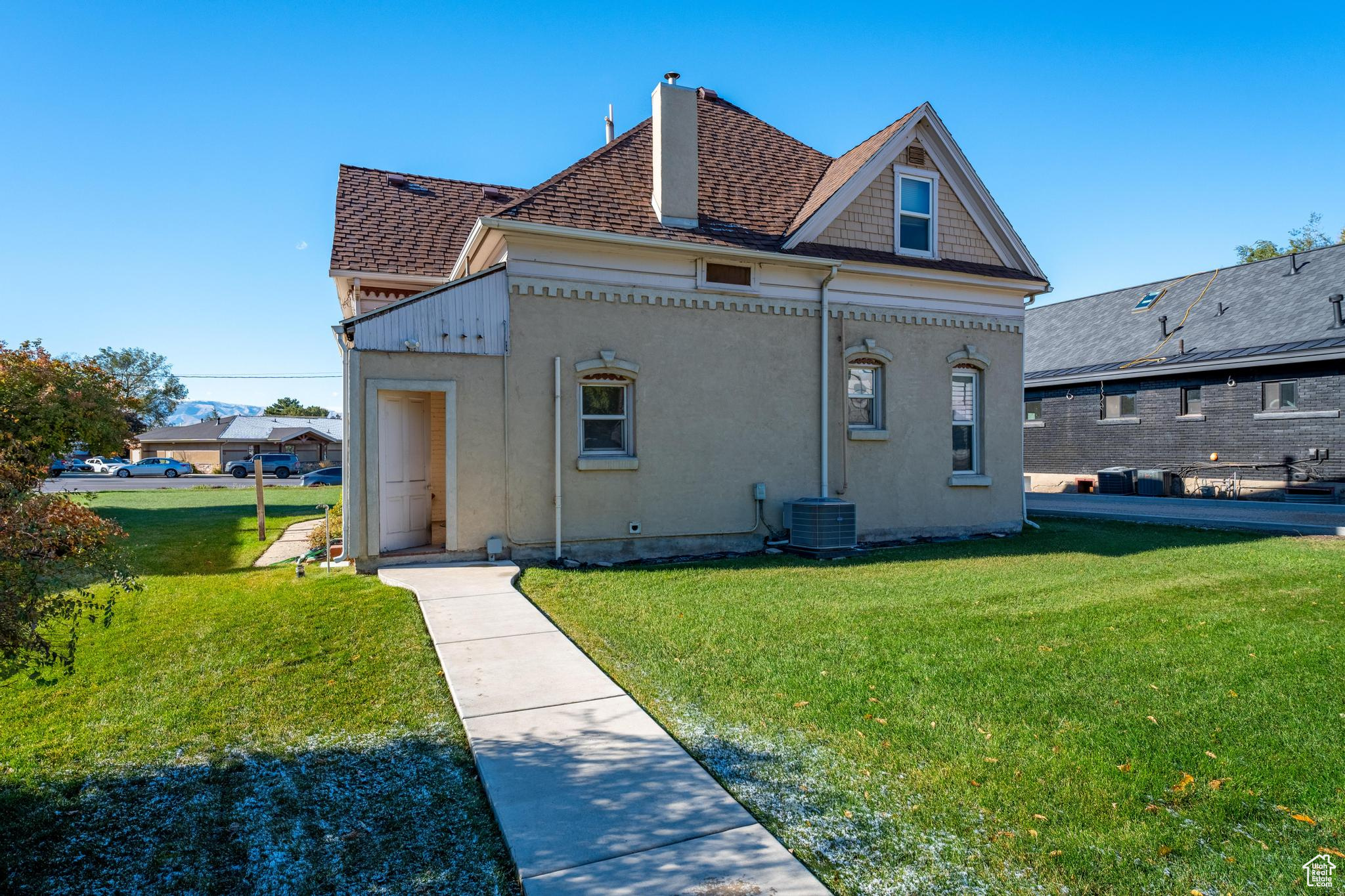 Rear view of property with a lawn