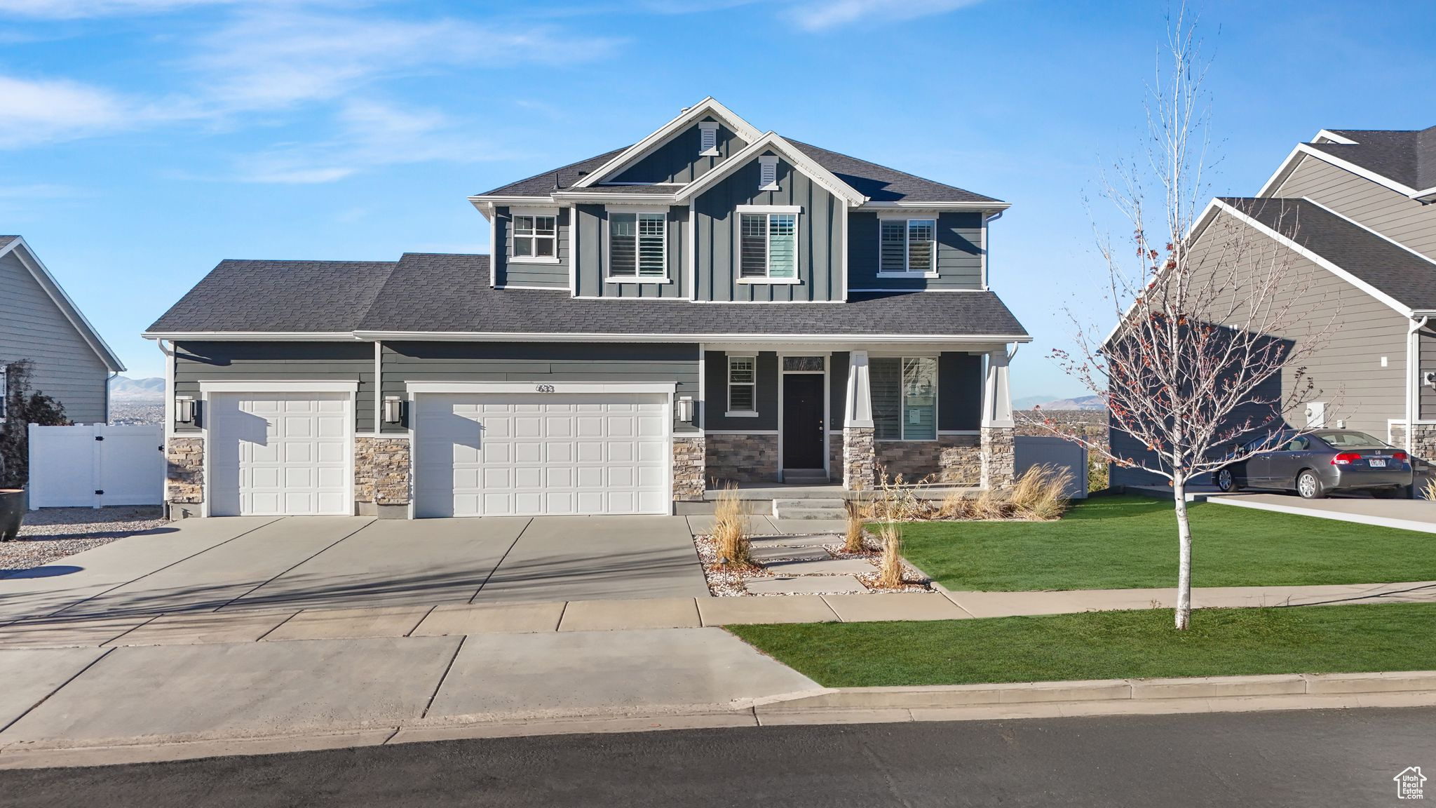 Craftsman house with a porch, a garage, and a front lawn