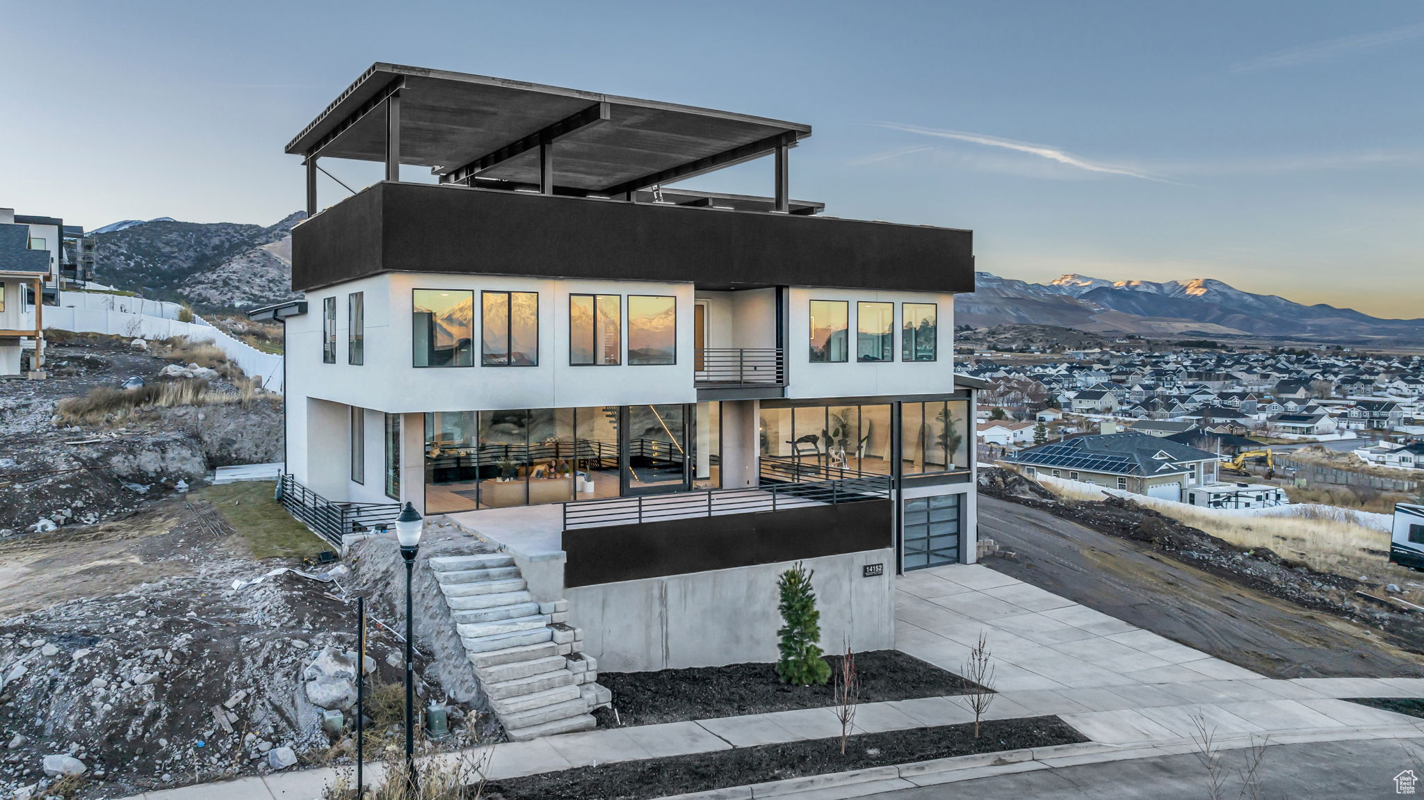 View of front of home featuring a mountain view and a balcony