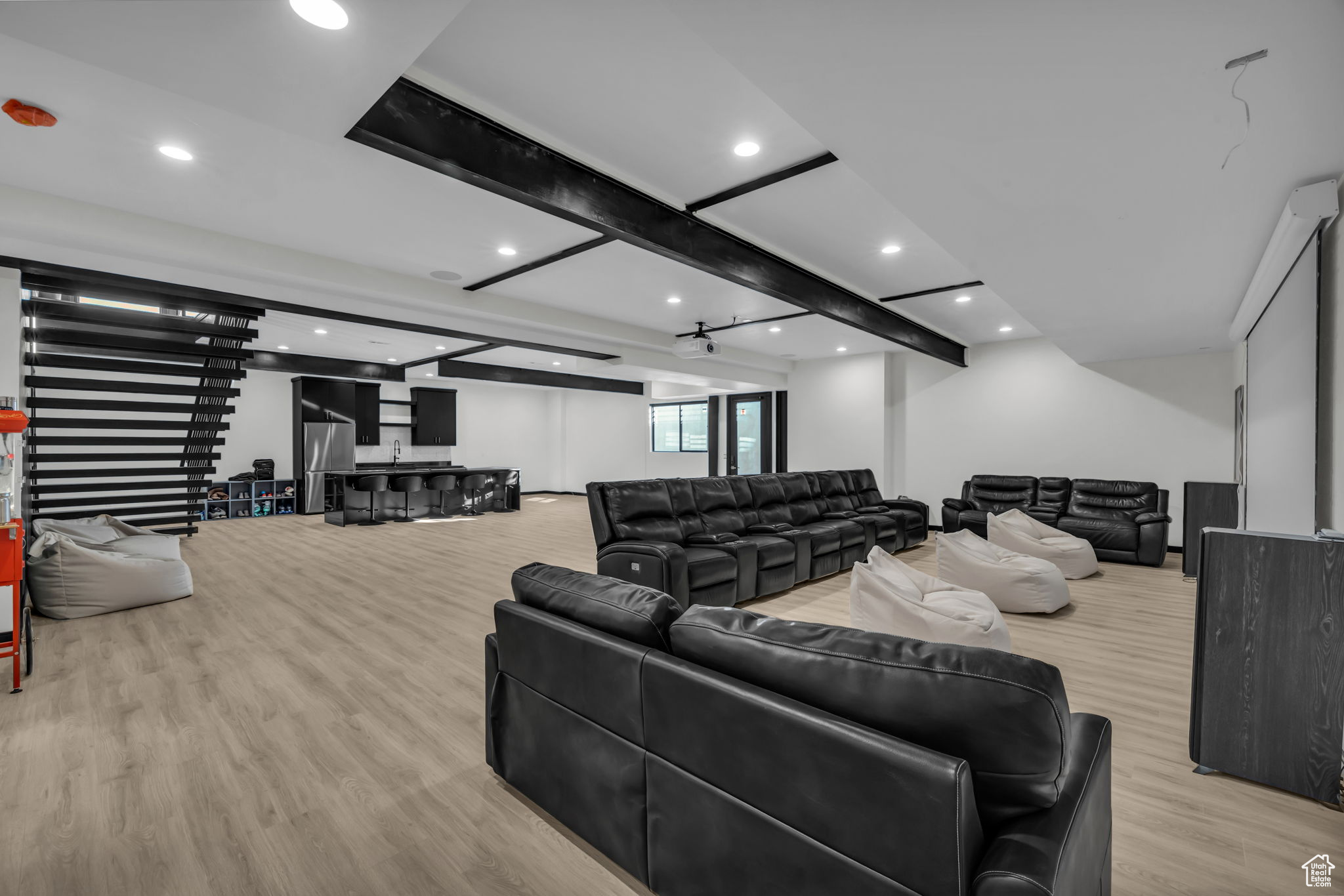 Living room featuring beam ceiling and light hardwood / wood-style floors