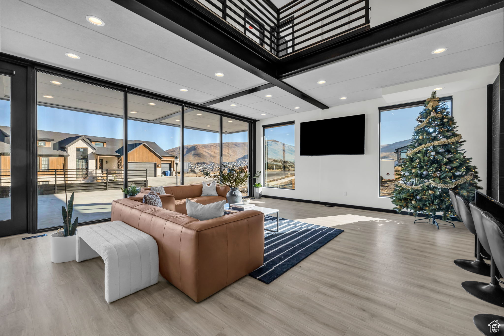 Living room with light wood-type flooring and a wealth of natural light