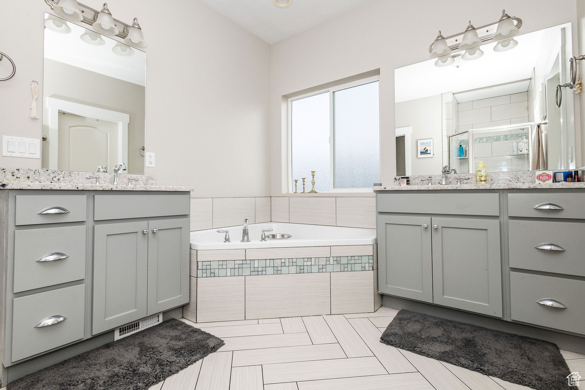 Bathroom with tile patterned flooring, vanity, and shower with separate bathtub