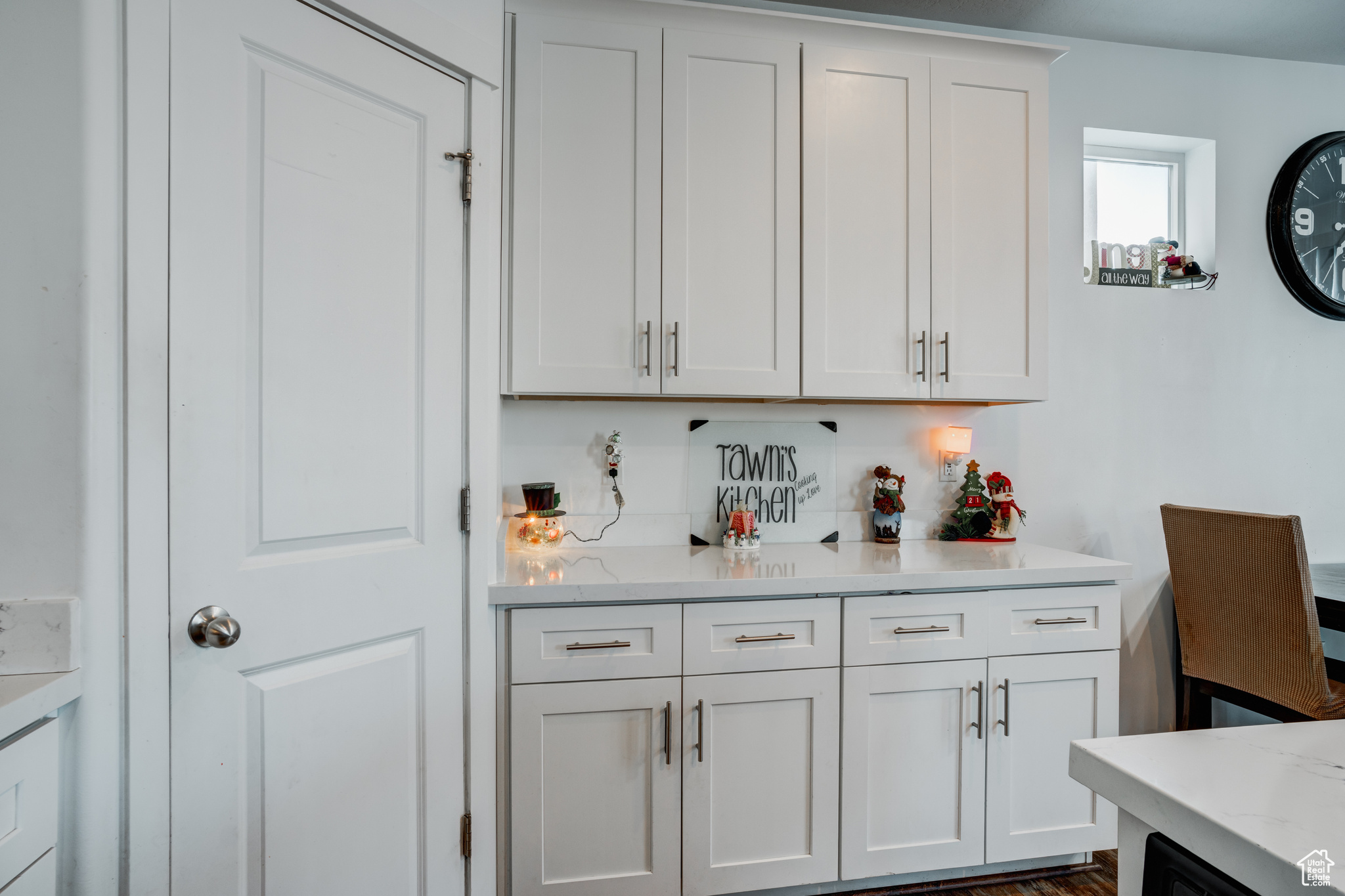 Bar with dark hardwood / wood-style floors, light stone countertops, white cabinetry, and tasteful backsplash