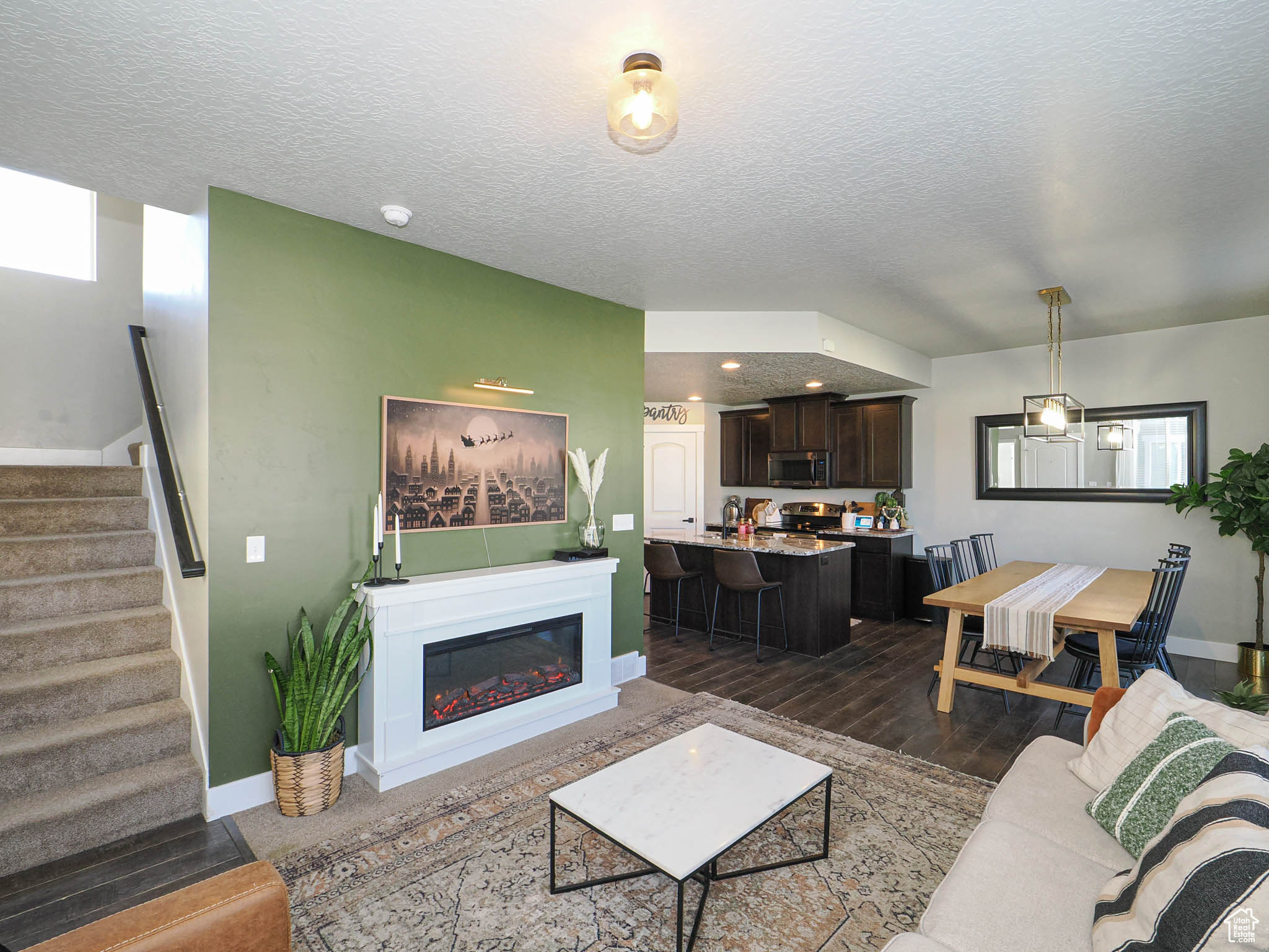 Living room with dark hardwood / wood-style floors and a textured ceiling