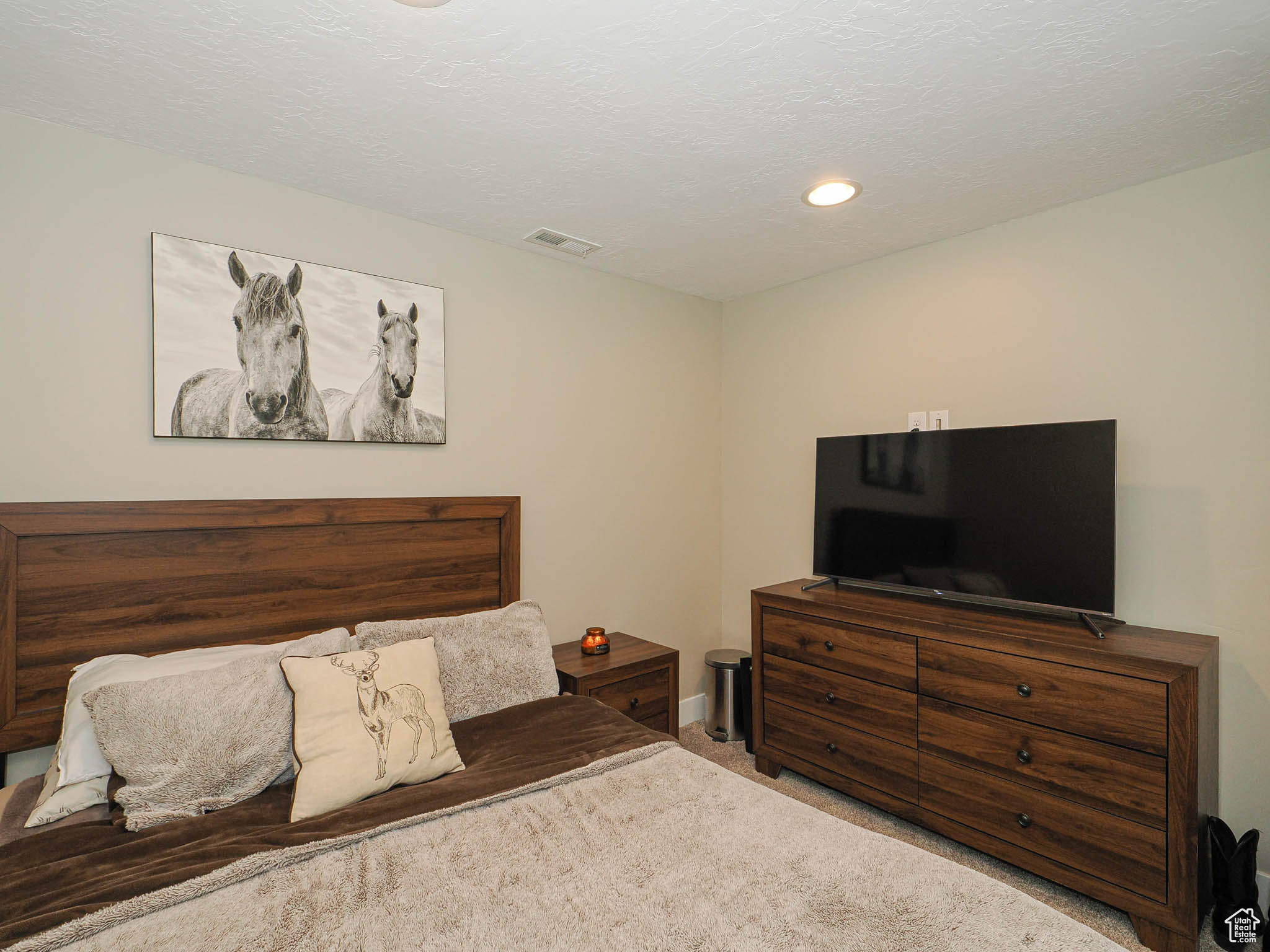 Carpeted bedroom featuring a textured ceiling