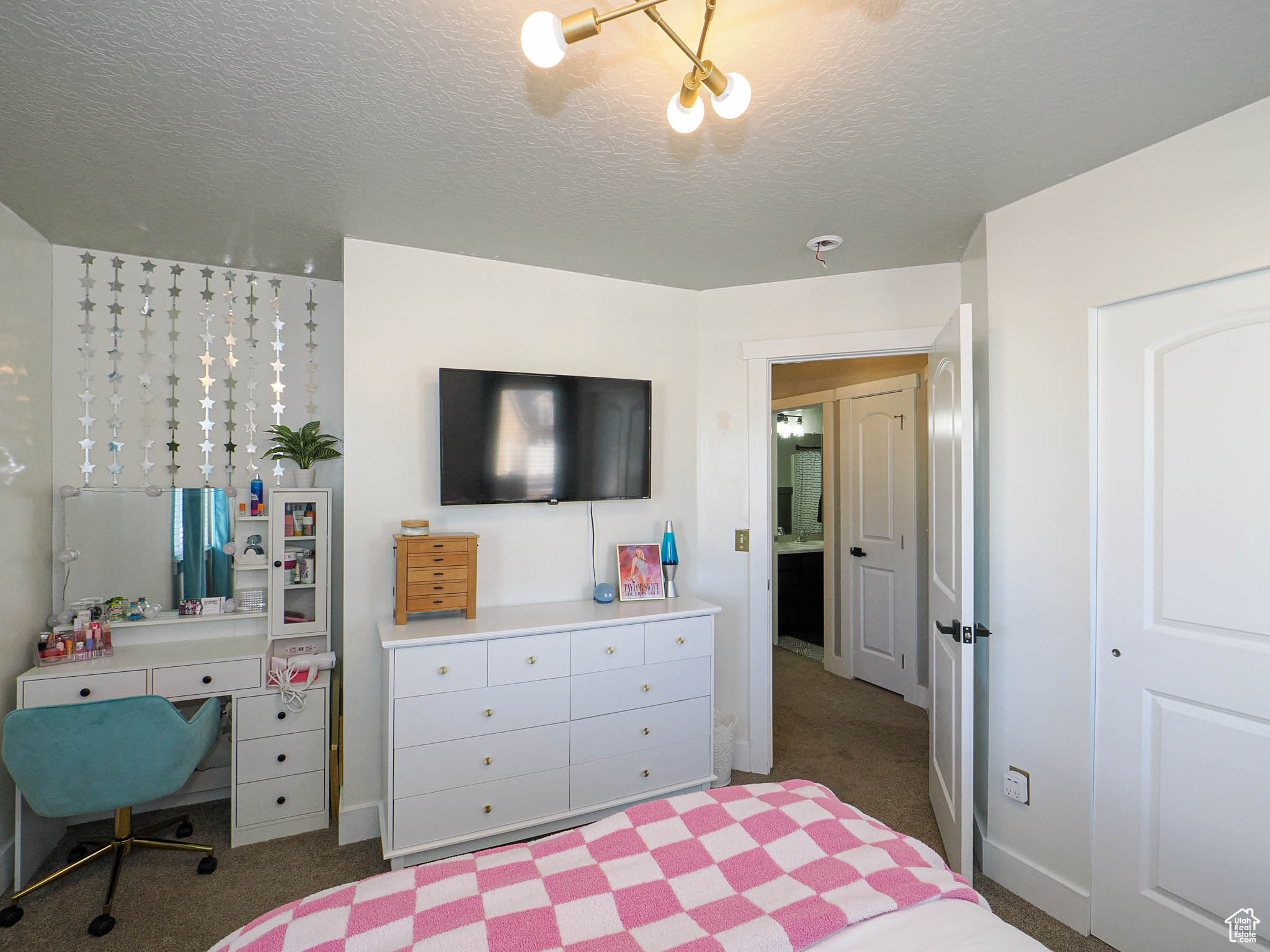 Carpeted bedroom with a textured ceiling