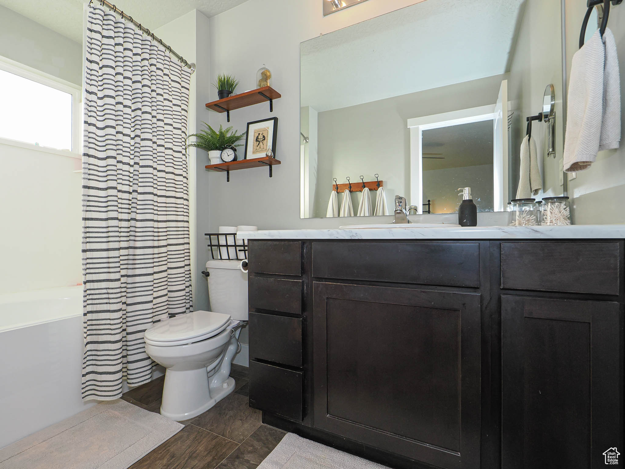 Bathroom with hardwood / wood-style floors, vanity, and toilet