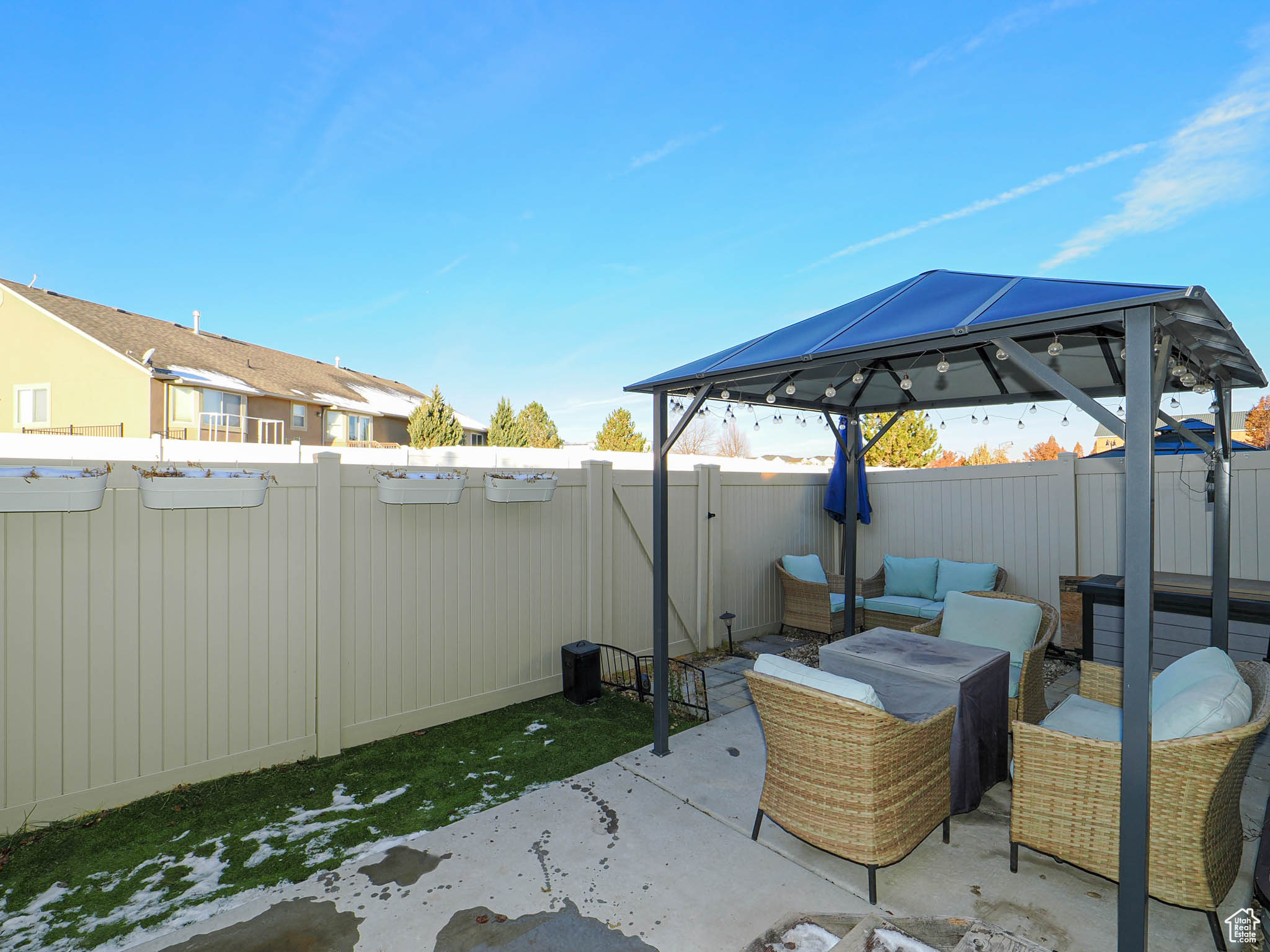 View of patio with a gazebo, an outdoor living space, and a hot tub