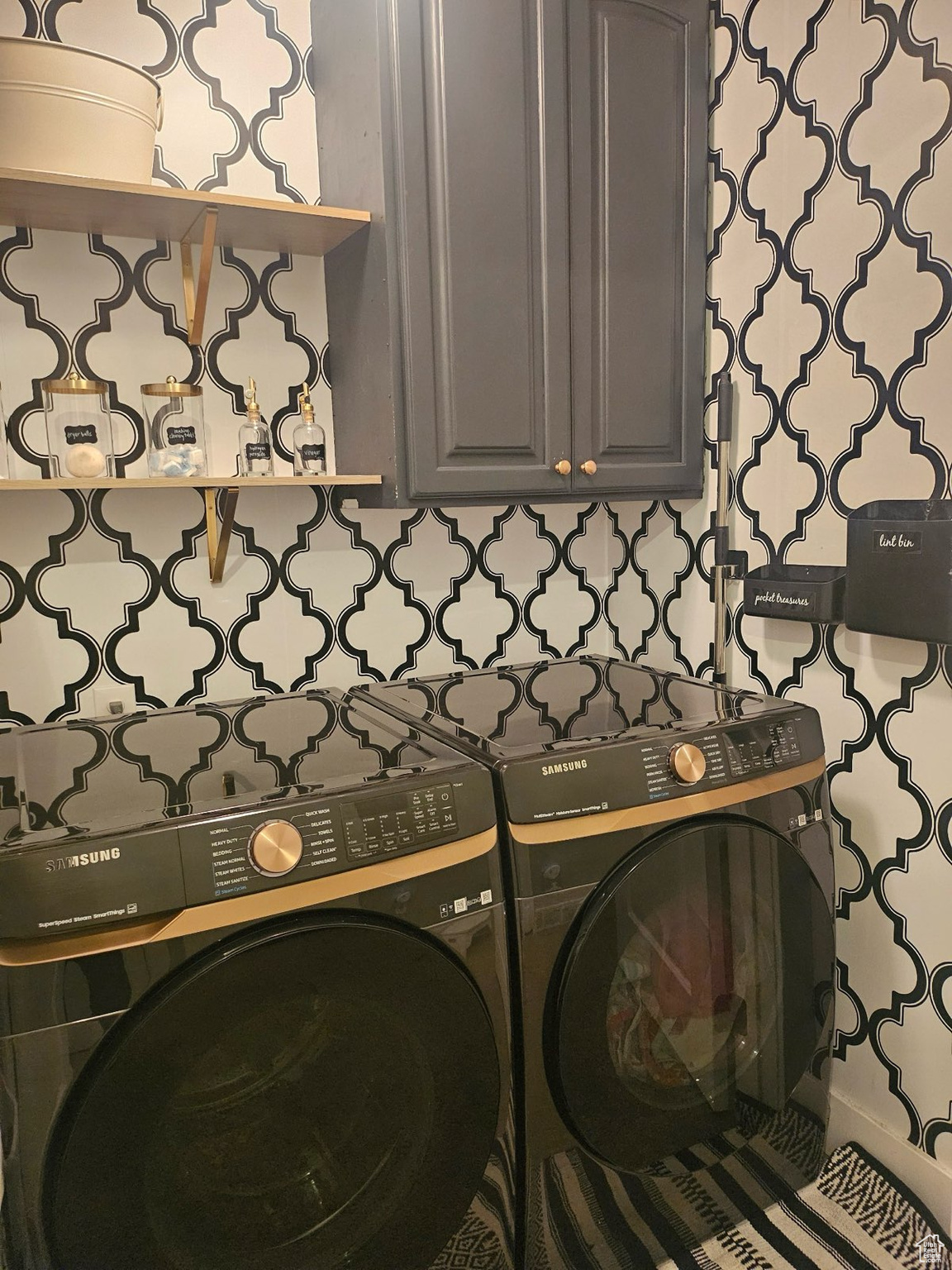 Laundry room with cabinets and washing machine and dryer