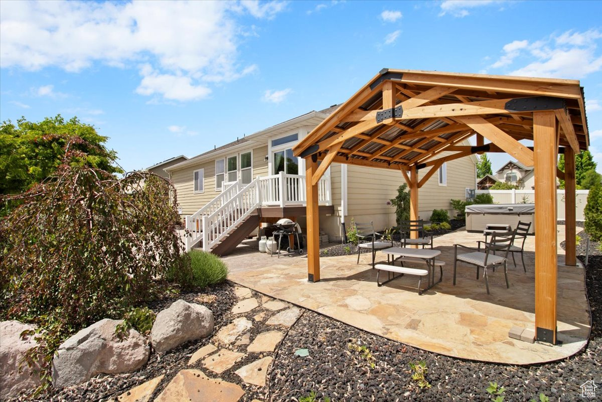 View of patio featuring a gazebo and a hot tub