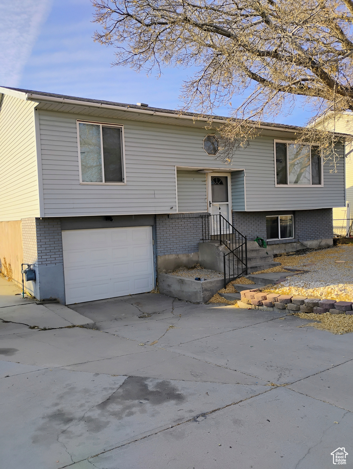 Split foyer home featuring a garage