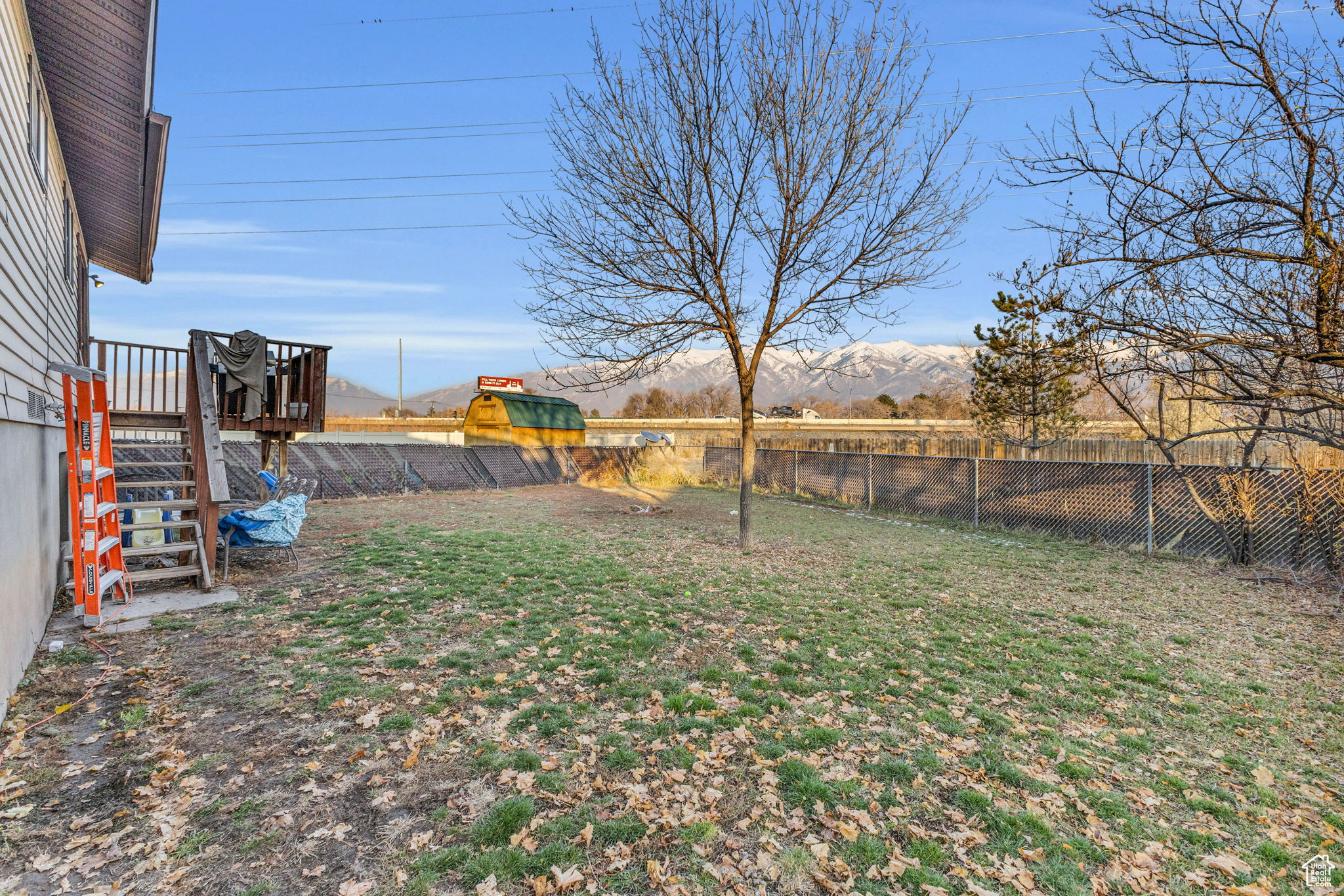 View of yard featuring a deck with mountain view