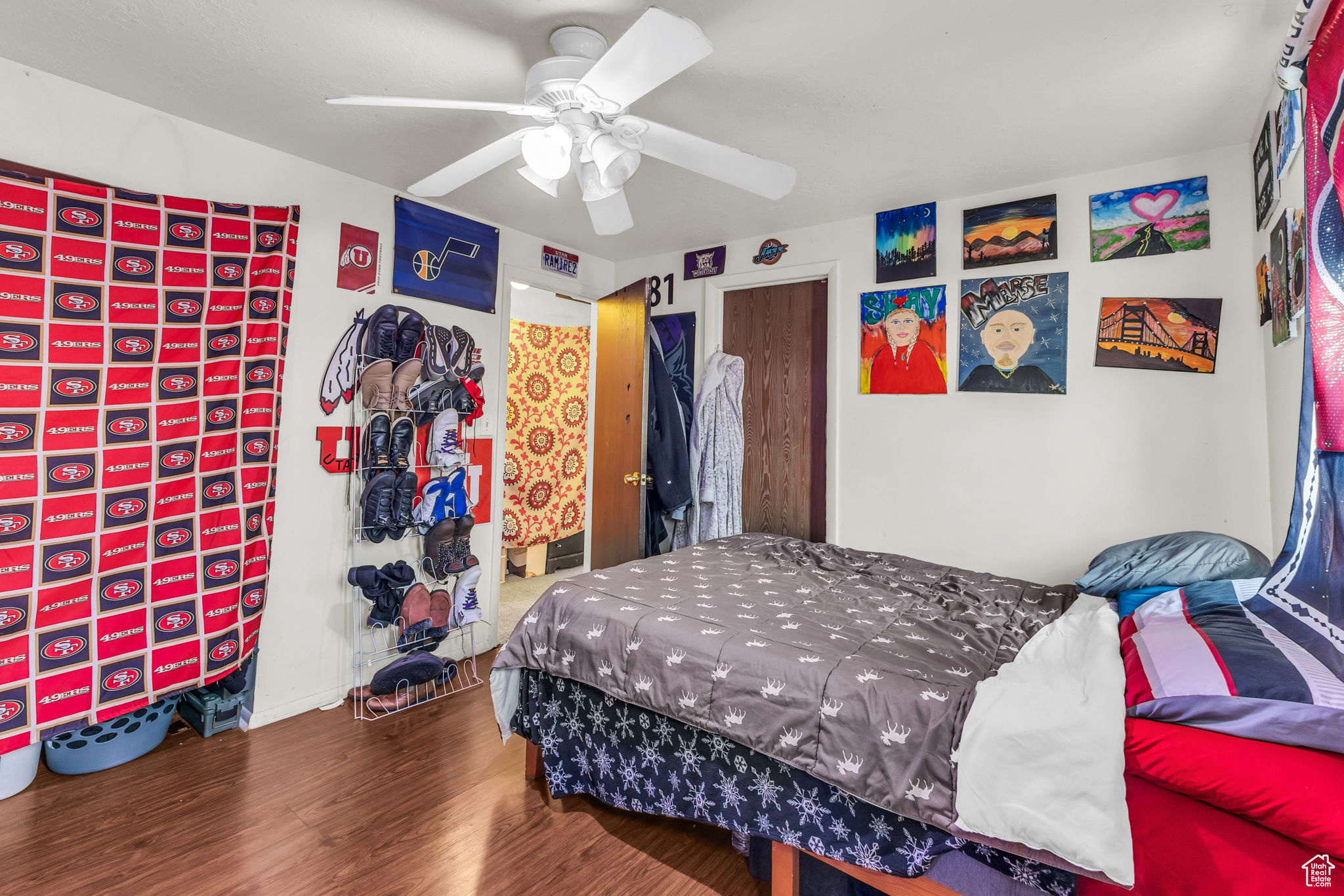 Bedroom with hardwood / wood-style floors and ceiling fan